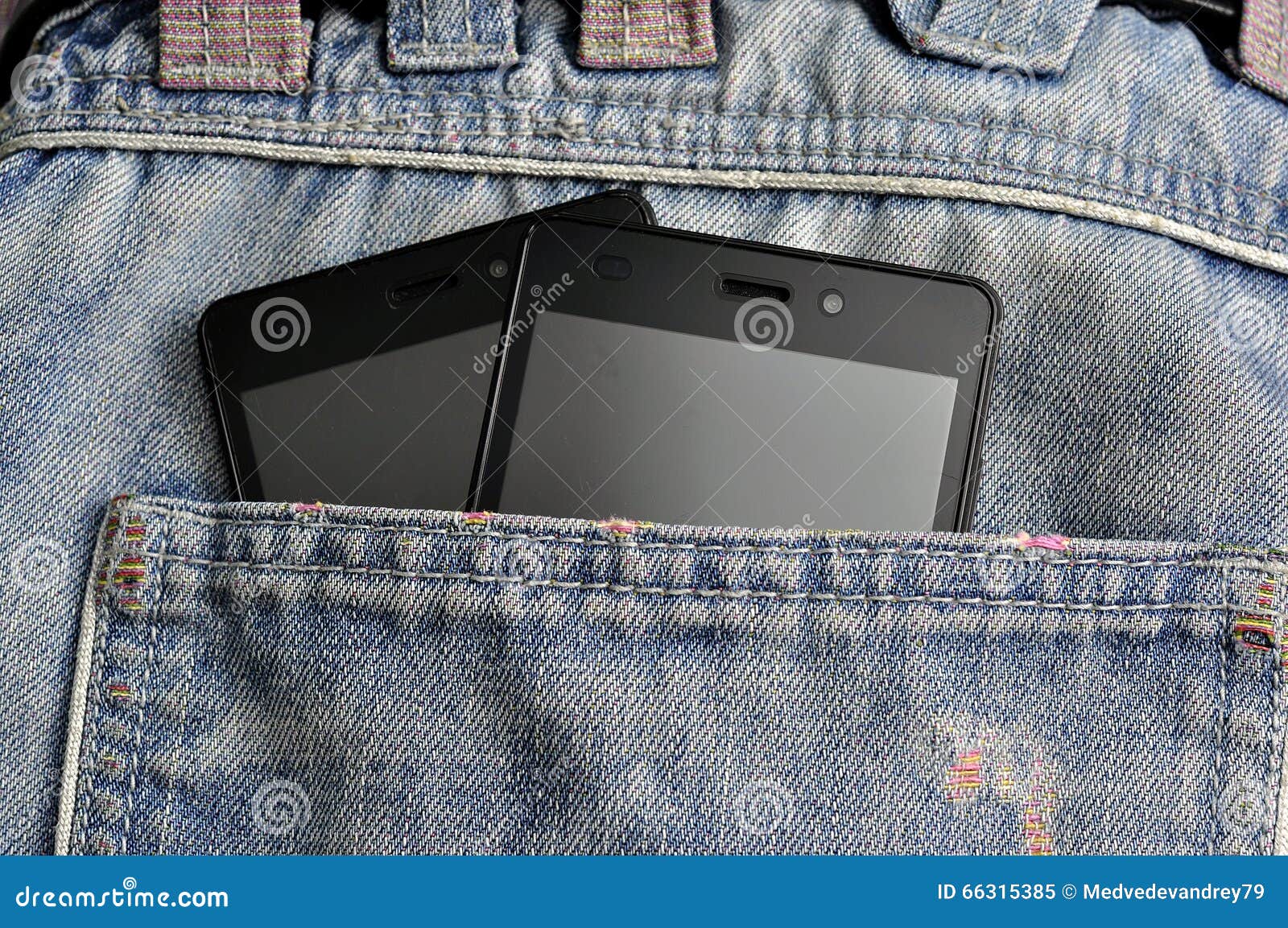 Double Mobile Phone, Cellphone in Back Pocket Blue Jeans Stock Image