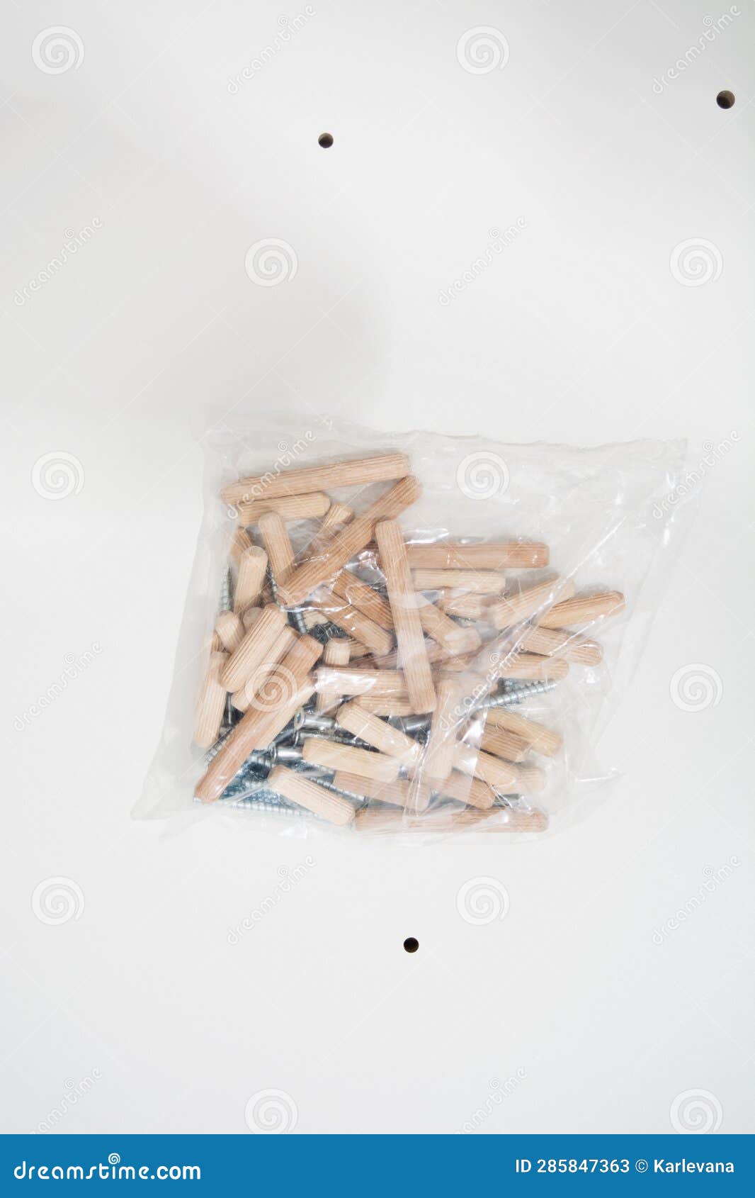 Dowels and Confirmates in Plastic Pack on White Furniture Shield Stock