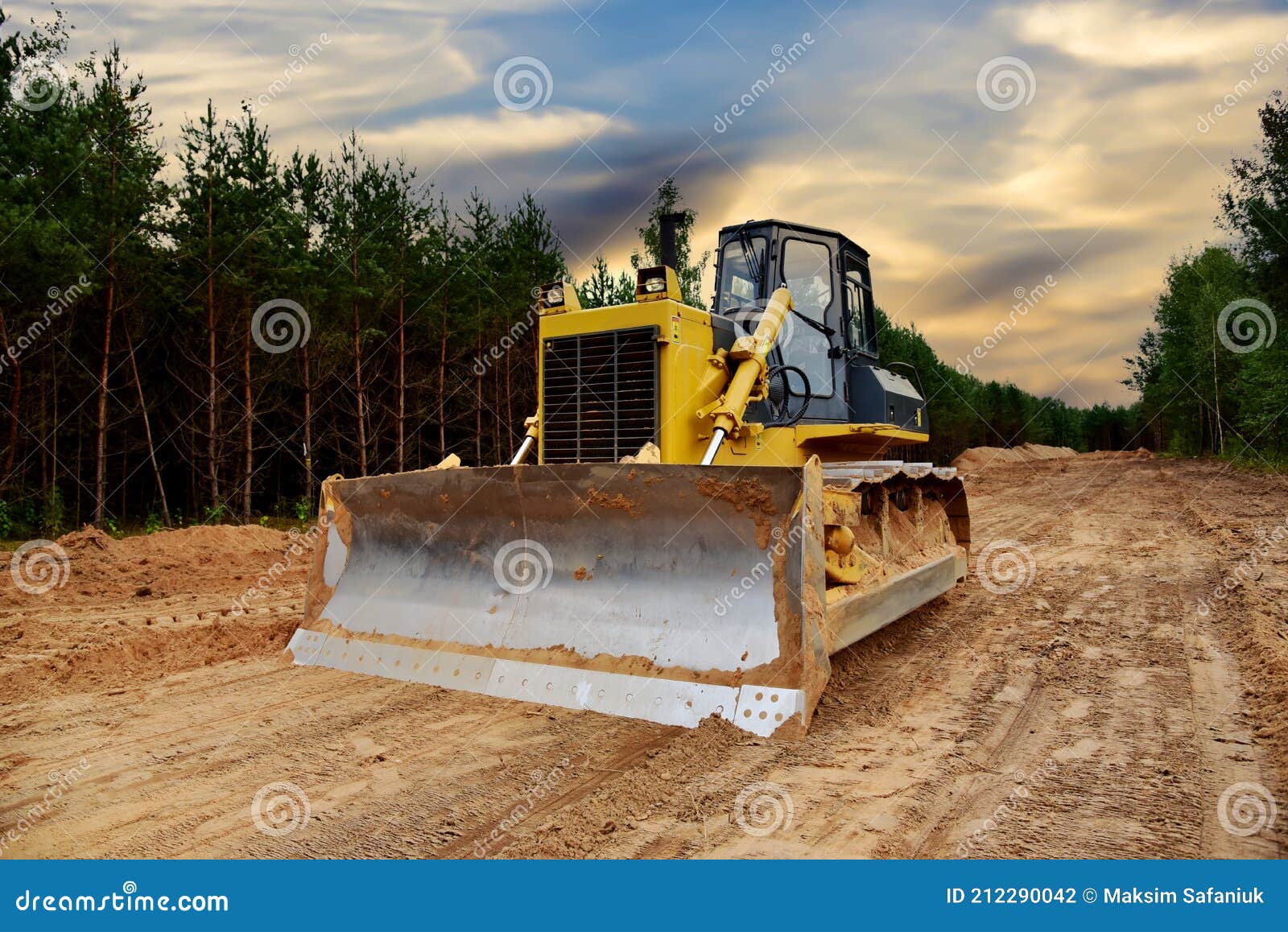 dozer during clearing forest for construction new road. bulldozer at forestry work on sunset background. earth-moving equipment at