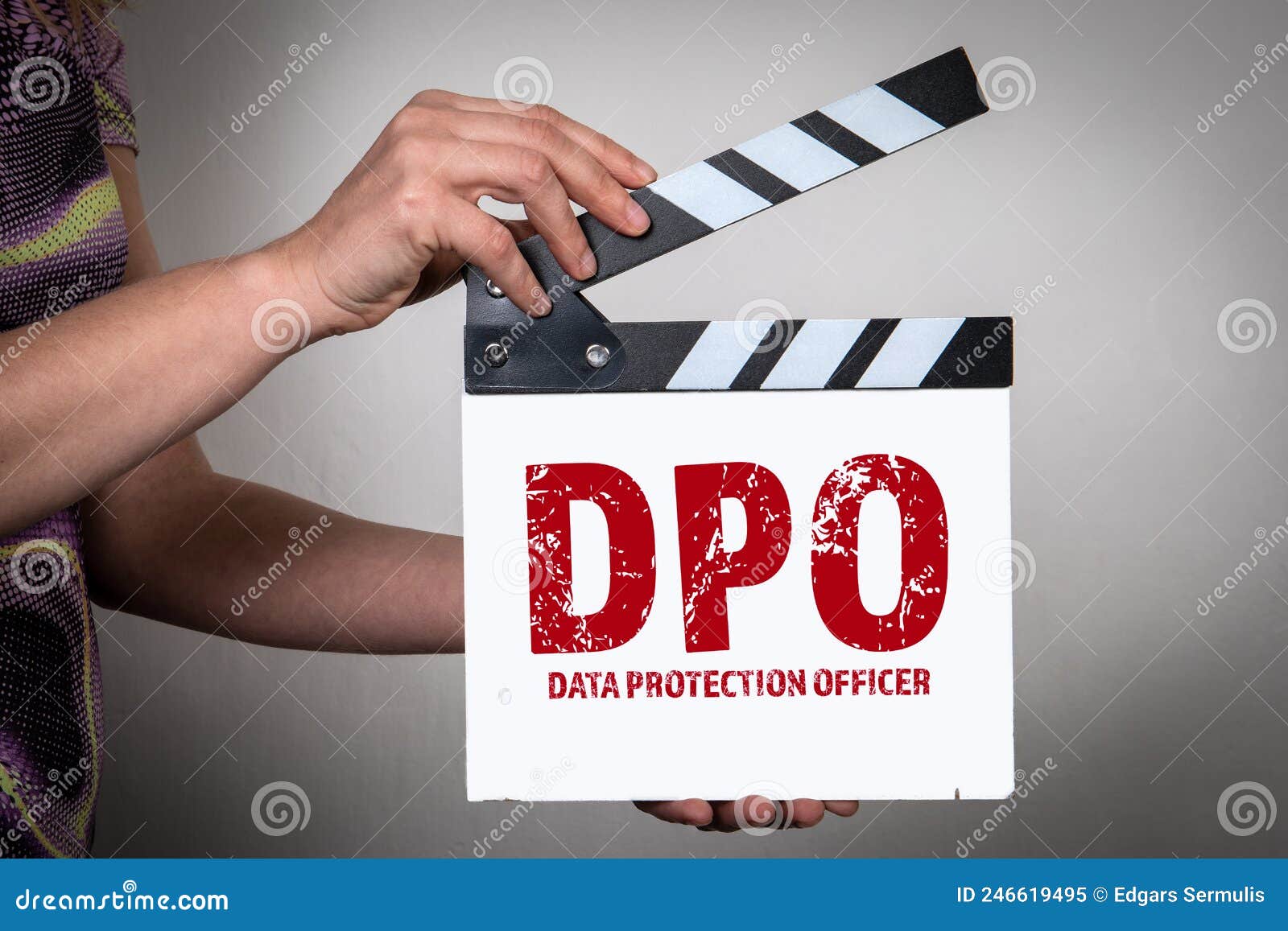 dpo data protection officer concept. female hands holding movie clapper