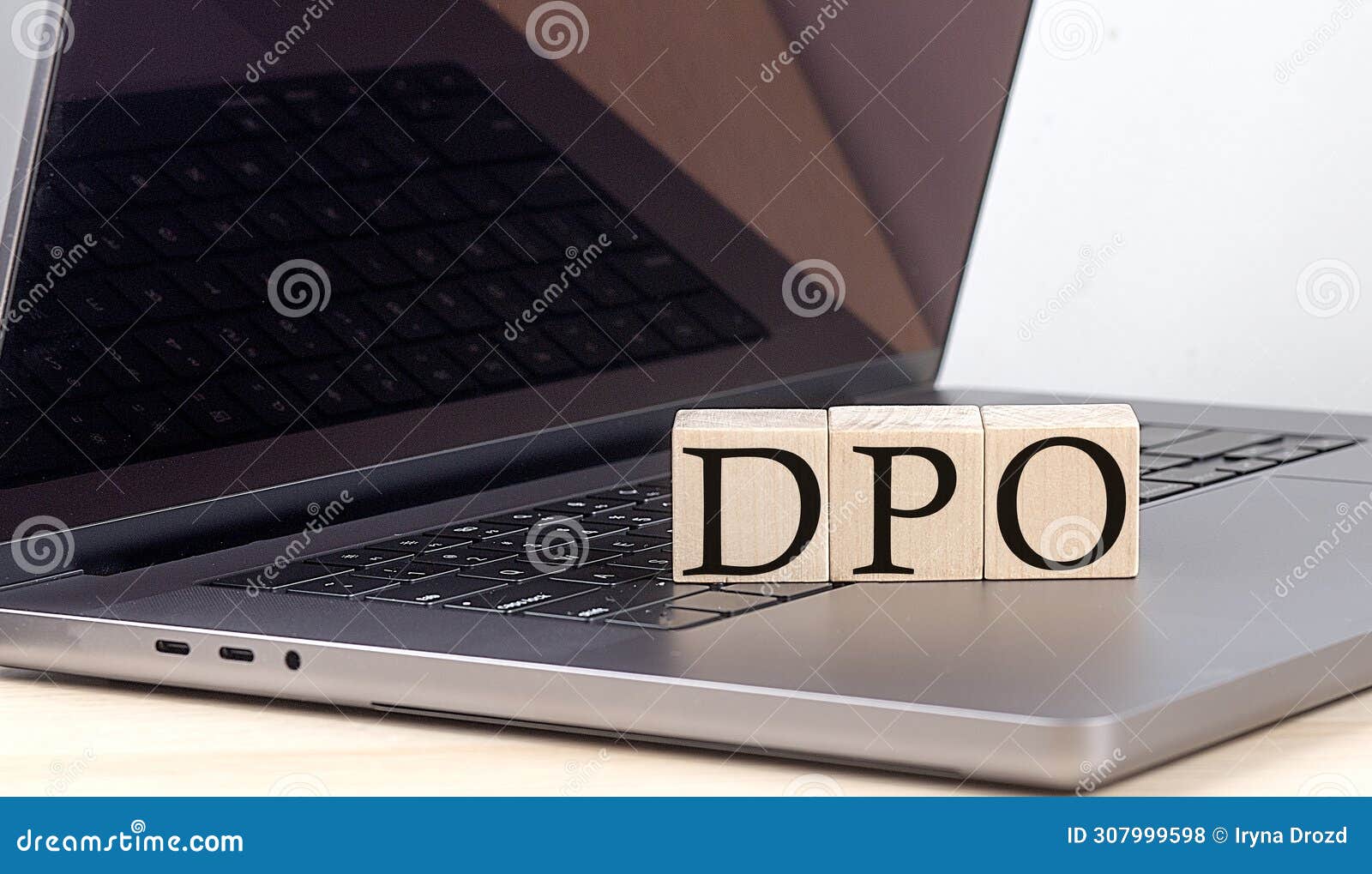 dpo word on wooden block on laptop, business concept