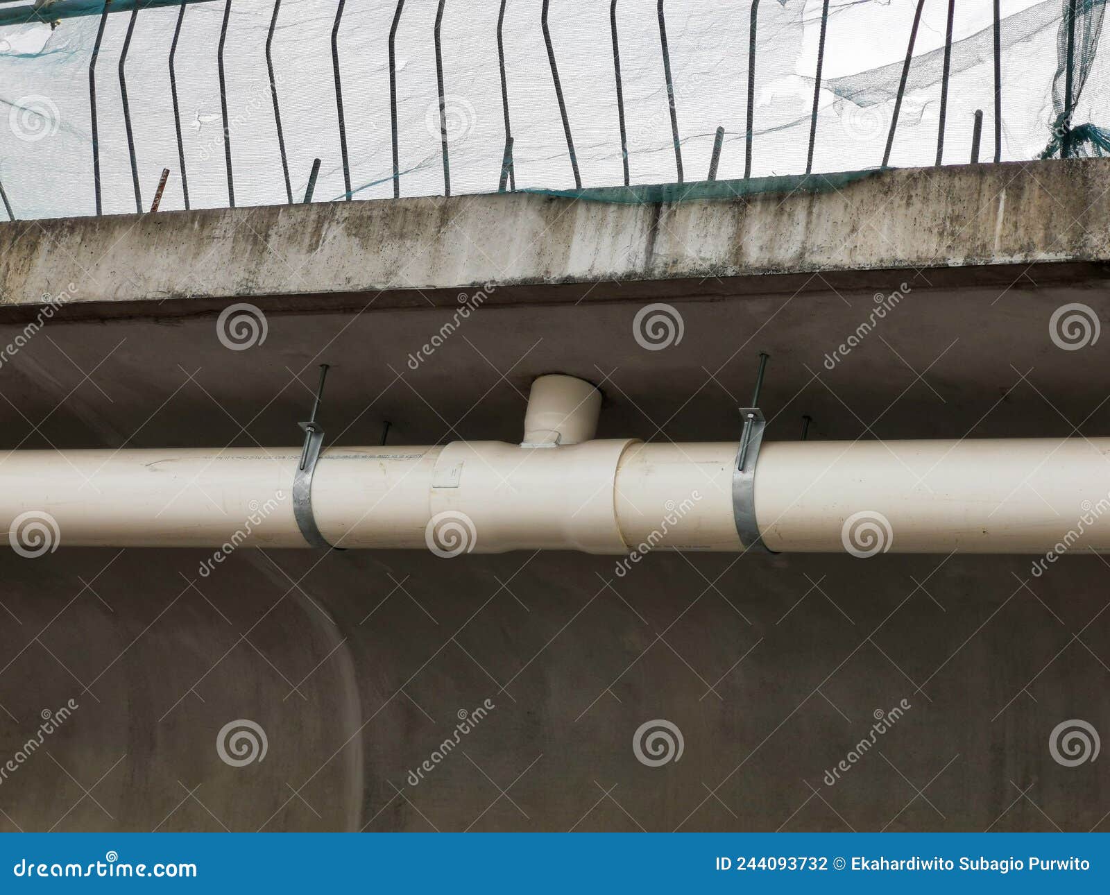 Drainage Pipe Mounted on the Concrete Brick Wall. Stock Photo Image