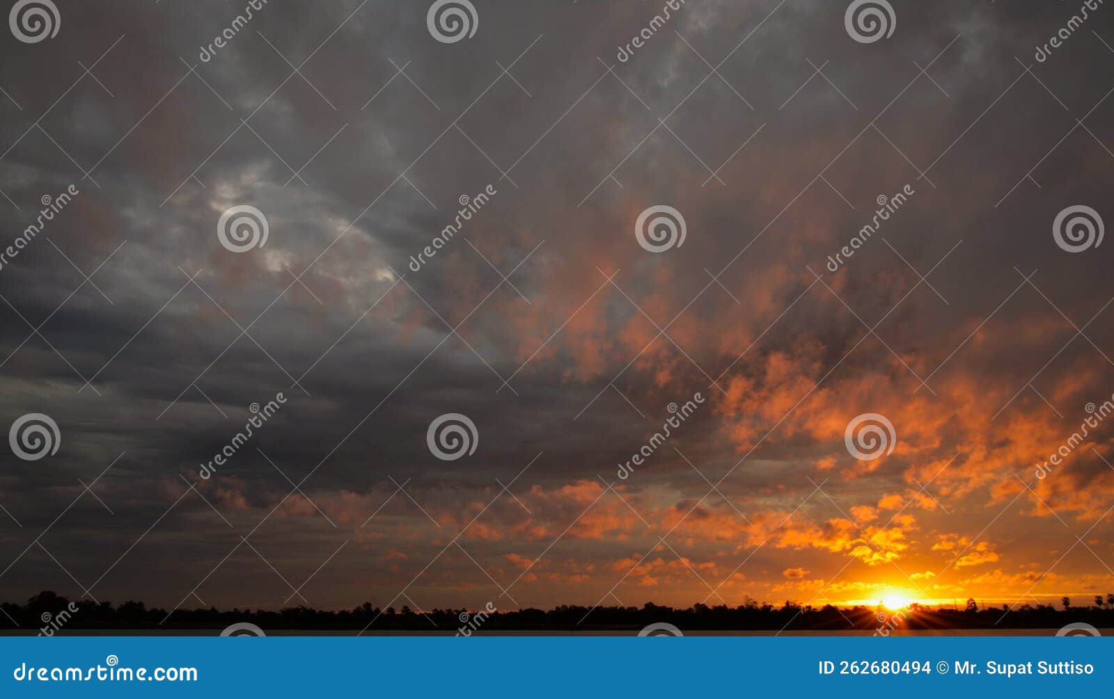 dramatic orange sky with black clouds at dusk, the weather is inclement. cover  template for book, magazine, website