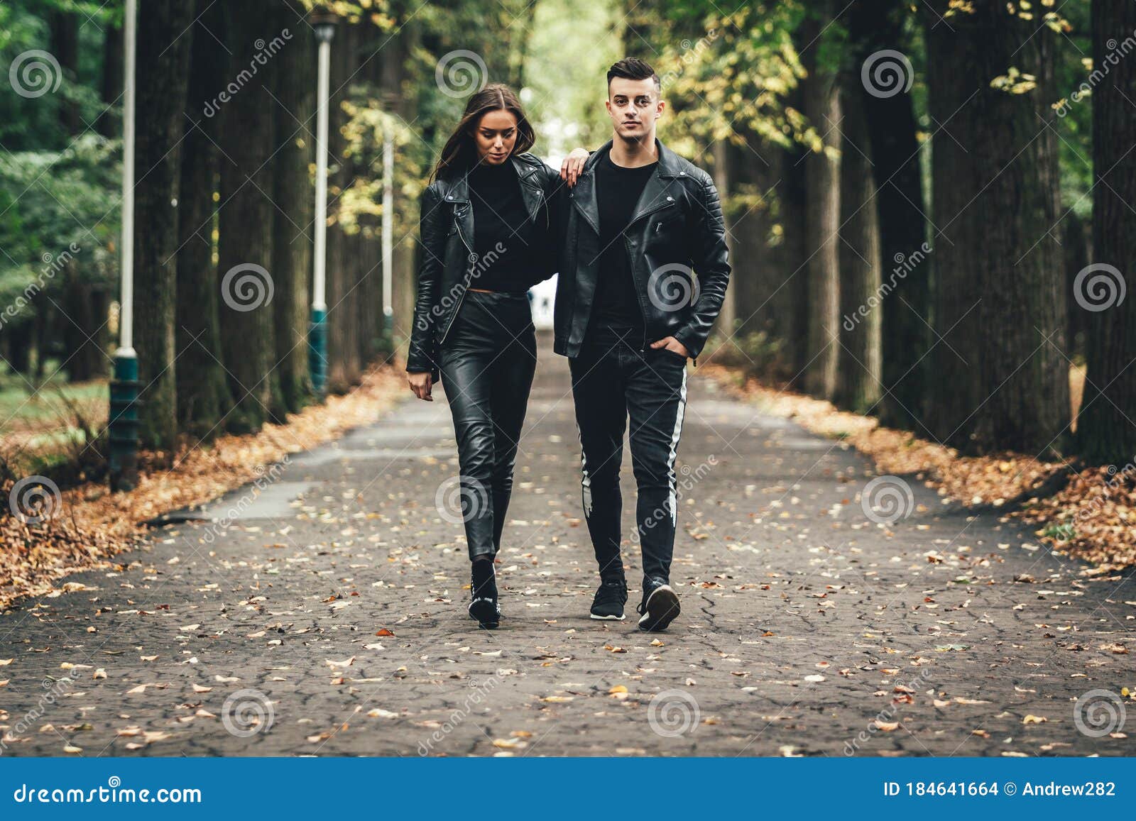 Dramatic Shot of Couple in Love Both Weard in Black Leather Jackets, Holding Hands and Strolling in Autumn Park. Stock Photo - Image of hair, happy: 184641664 Dramatic Shot of Couple in Love Both Weard in Black Leather Jackets, Holding Hands and Strolling in Autumn Park. Stock Photo - Image of hair, happy: 184641664