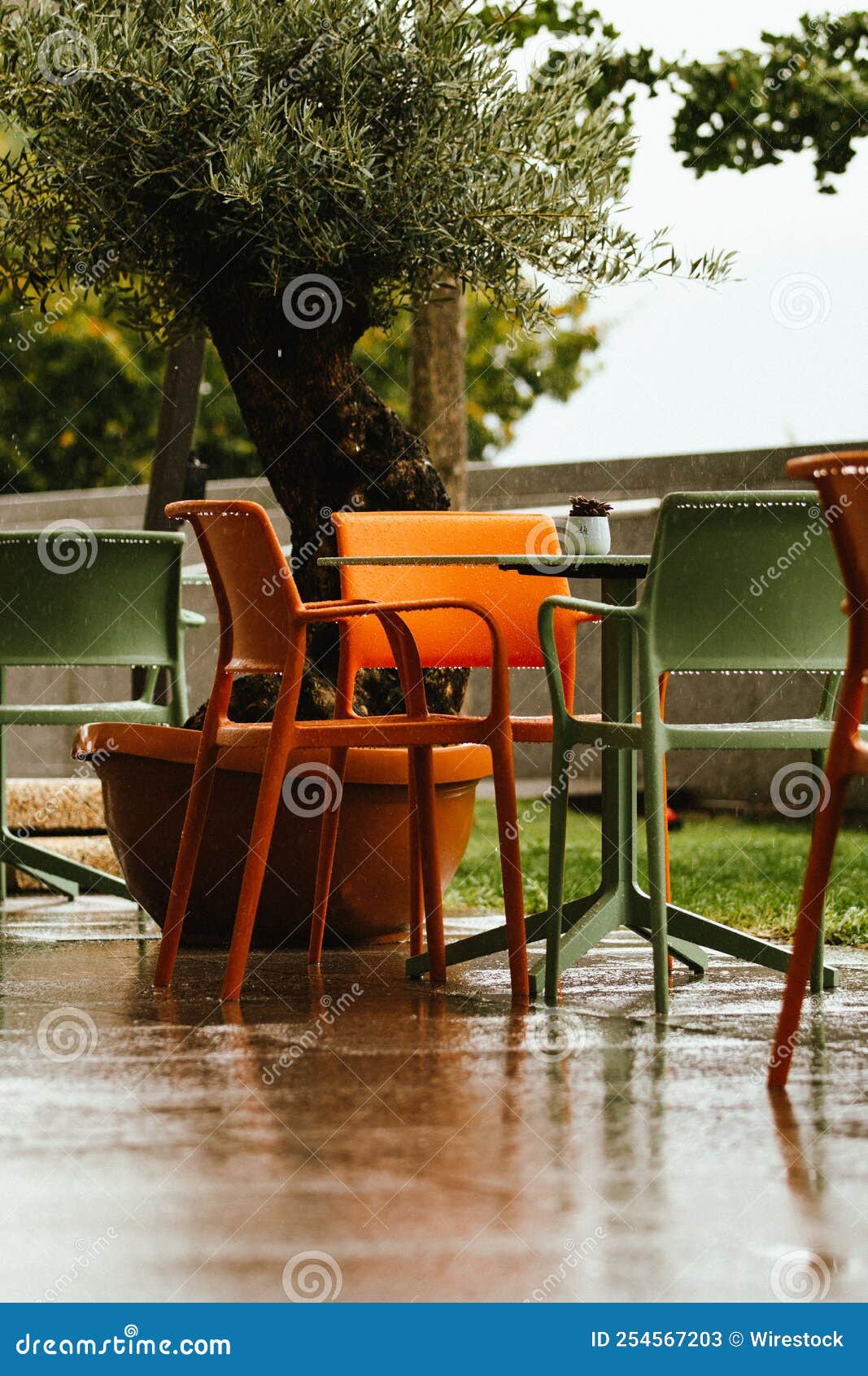 Dramatic Shot of a Table and Chairs on a Rainy Day Stock Image - Image
