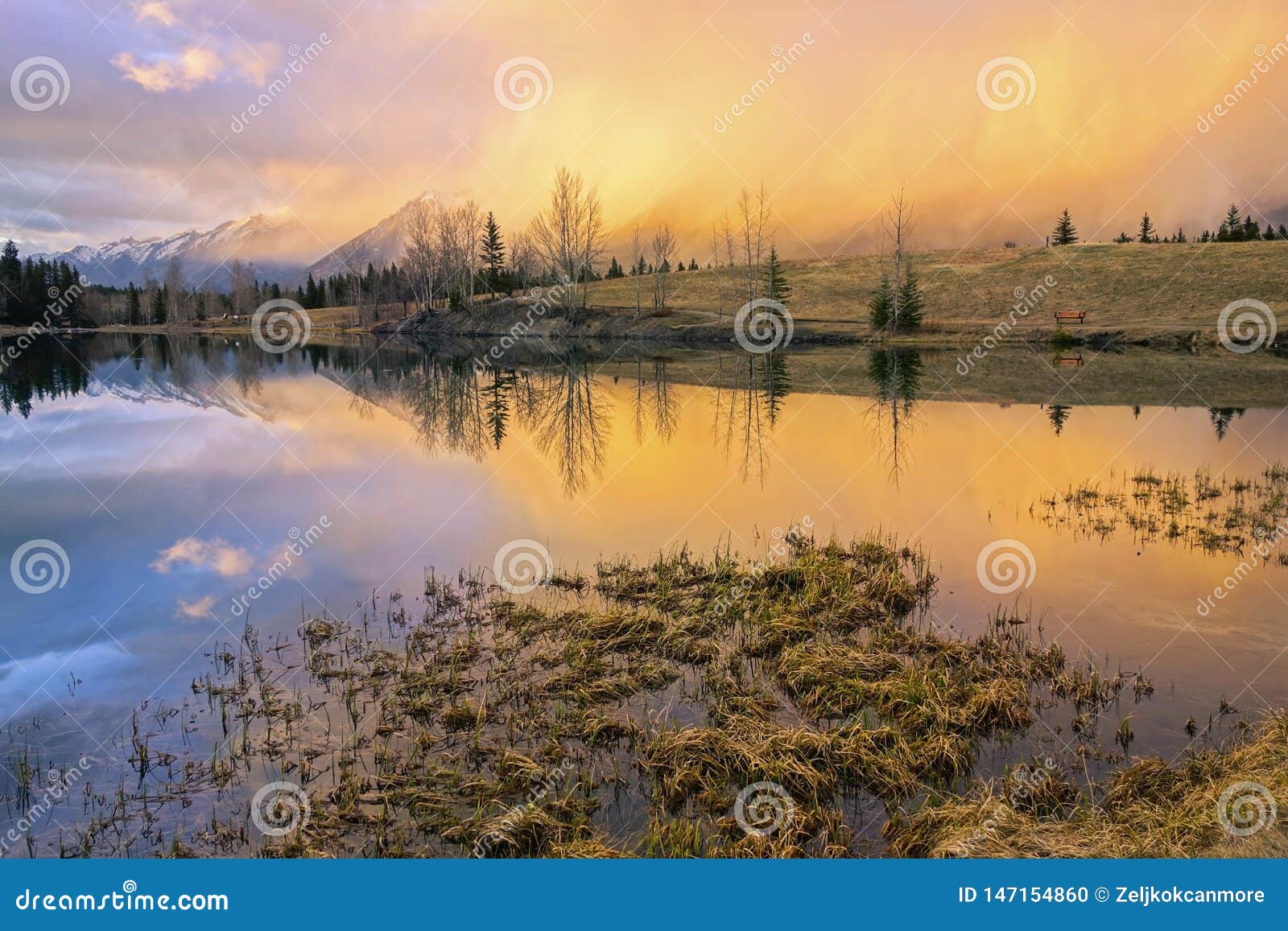 dramatic springtime sunset colors blue lake canada landscape alberta foothills