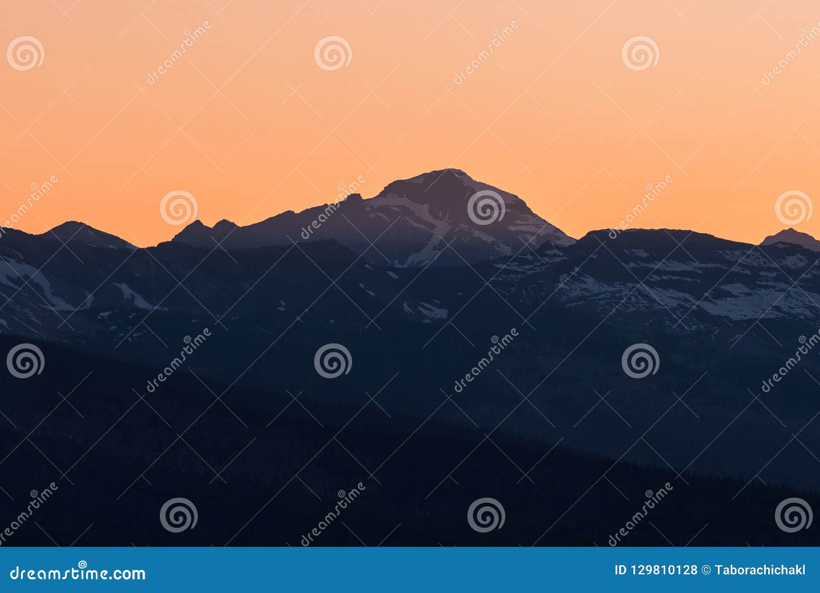 dramatic sun rays behind heaven`s peak, glacier national park, montana