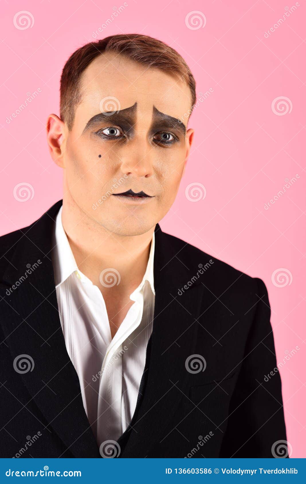 dramatic and tragic. unhappy mime with face paint. theatre actor miming. mime artist. man with mime makeup. stage actor