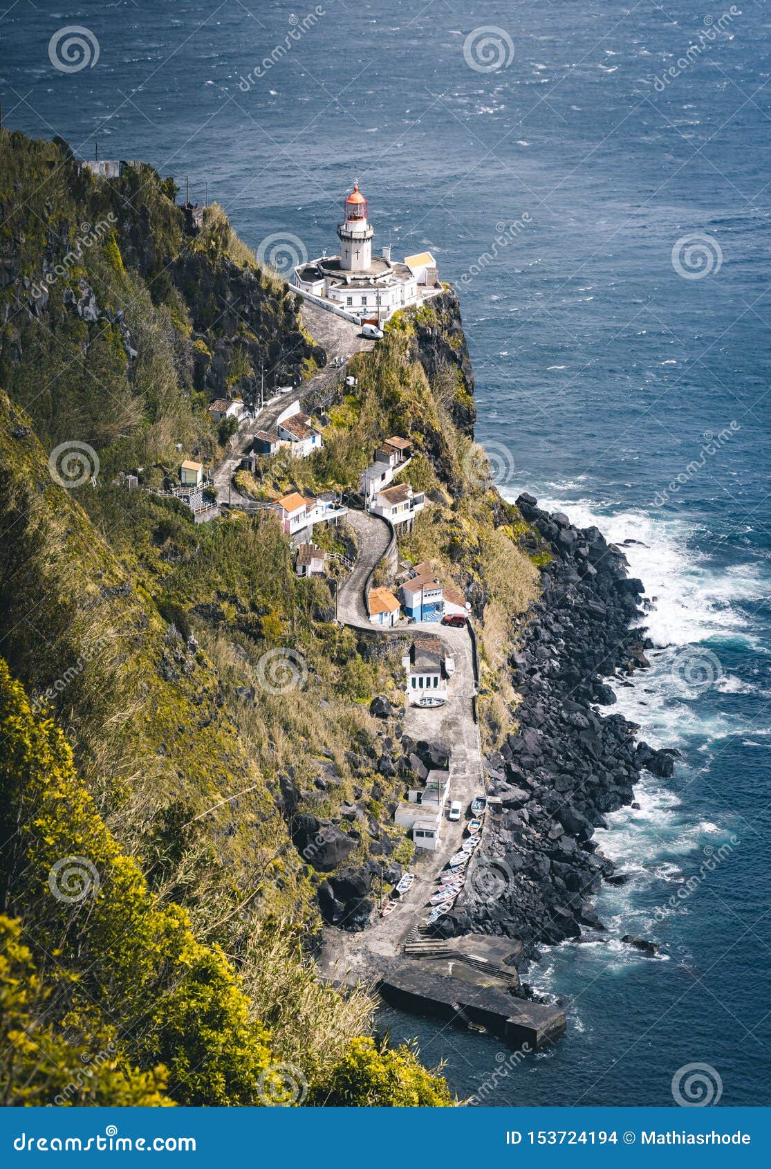 dramatic view down to lighthouse on ponta do arnel, nordeste, sao miguel island, azores, portugal