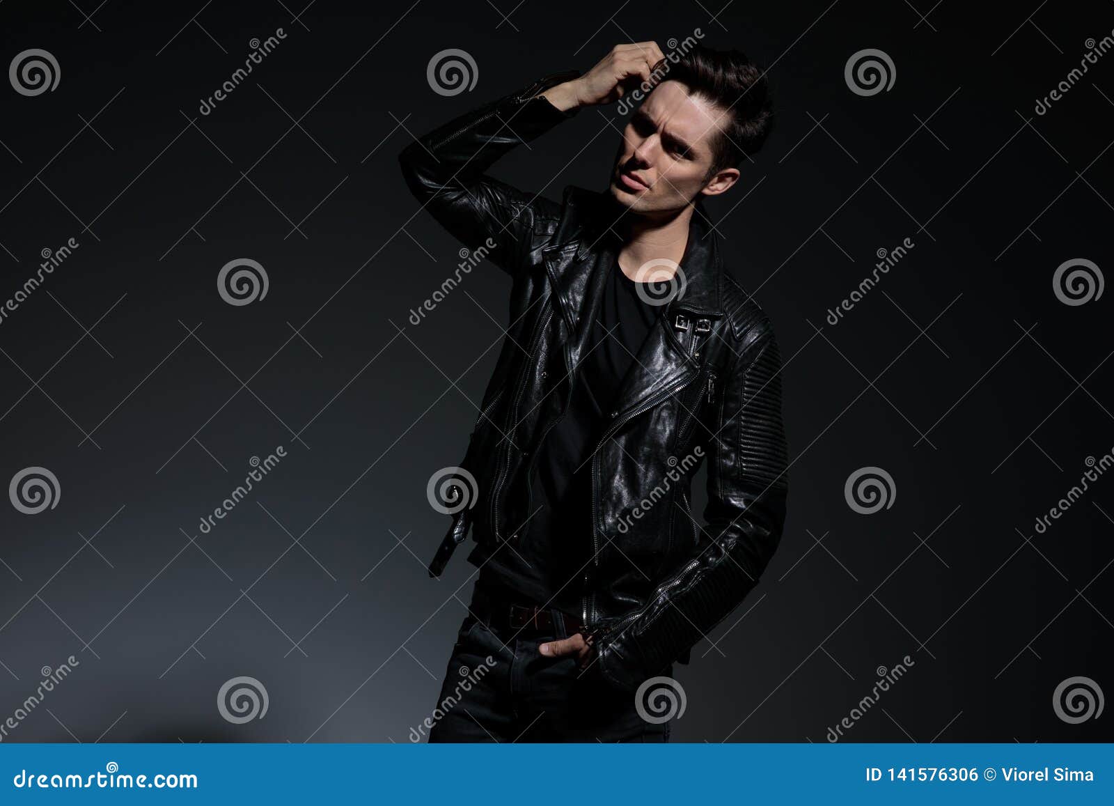 Dramatic Young Man in Leather Jacket Fixes His Hairstyle Stock Photo ...