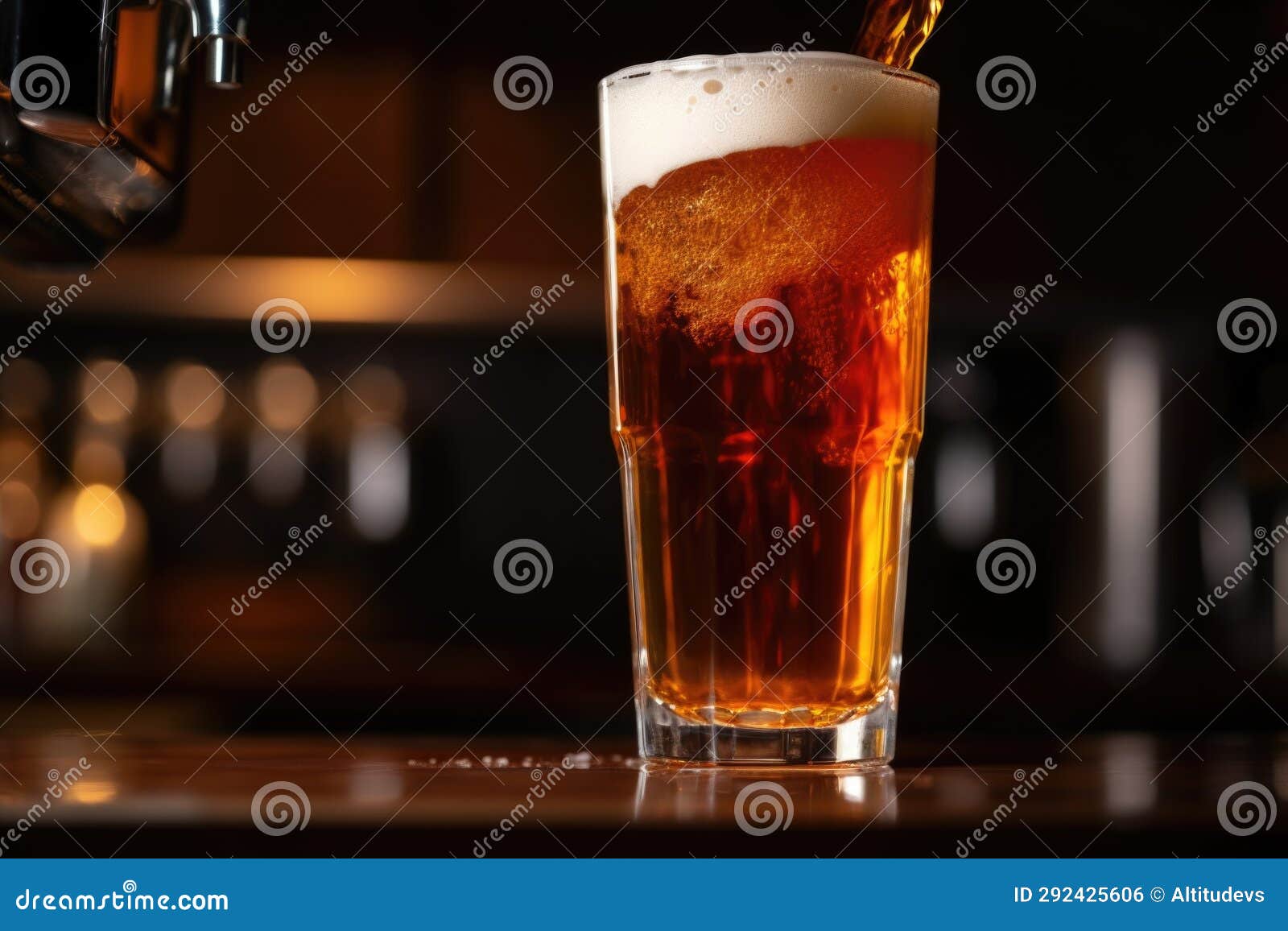 Drawing a Frothy Glass of Amber Ale from a Beer Tap Stock Photo Image