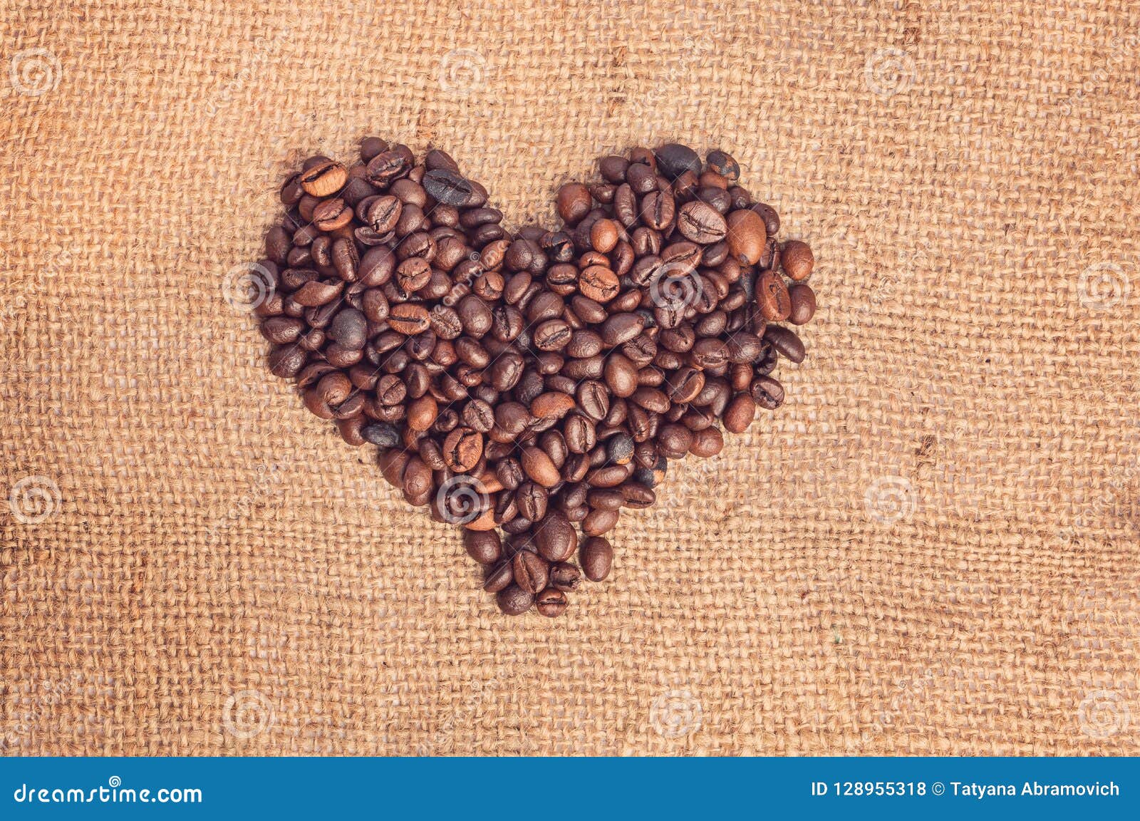 Drawing a Heart from Coffee Beans on Burlap. Vintage Style Stock Photo