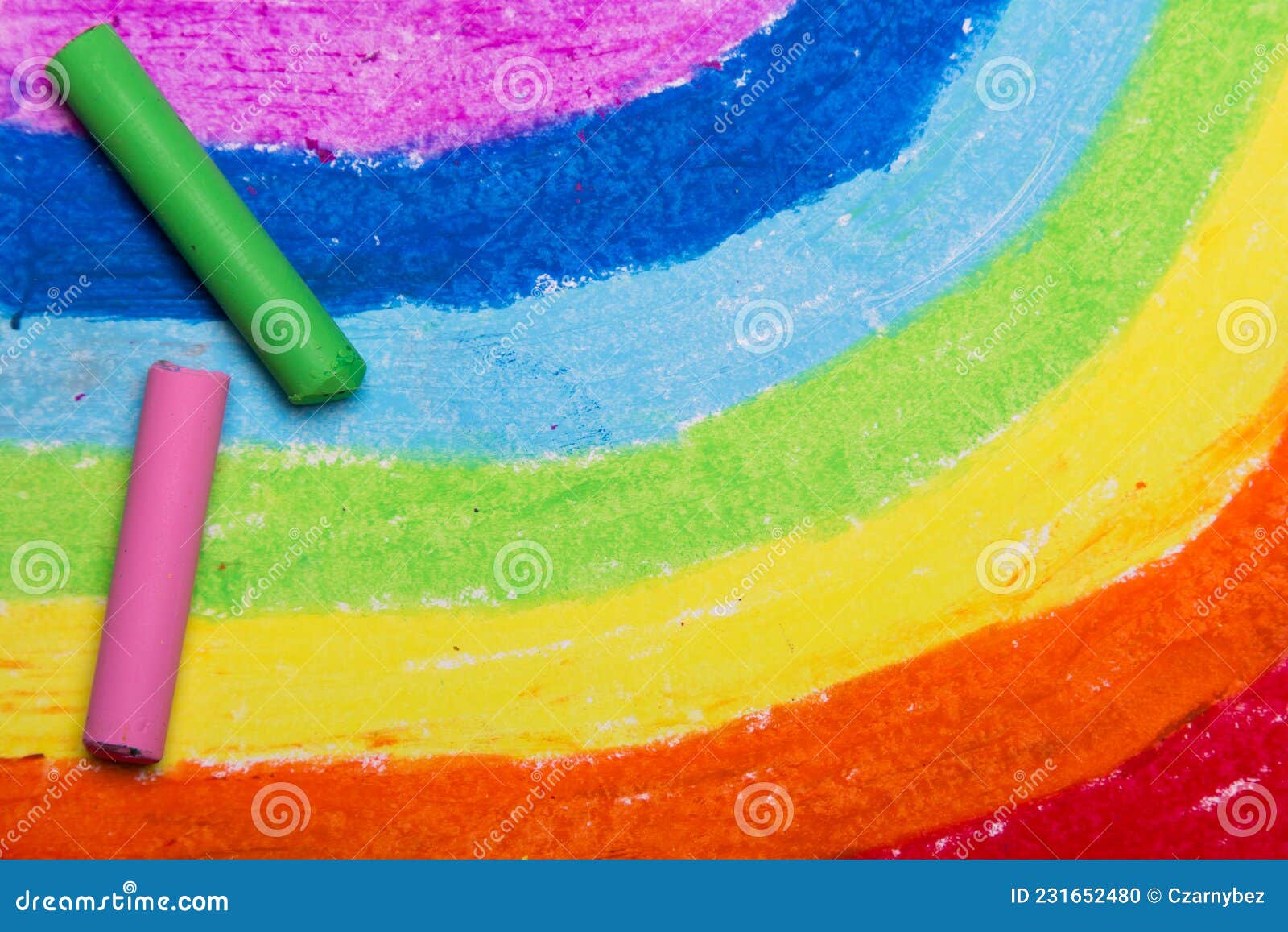 Closeup Of Oil Pastel Crayons And A Drawn Rainbow Stock Photo