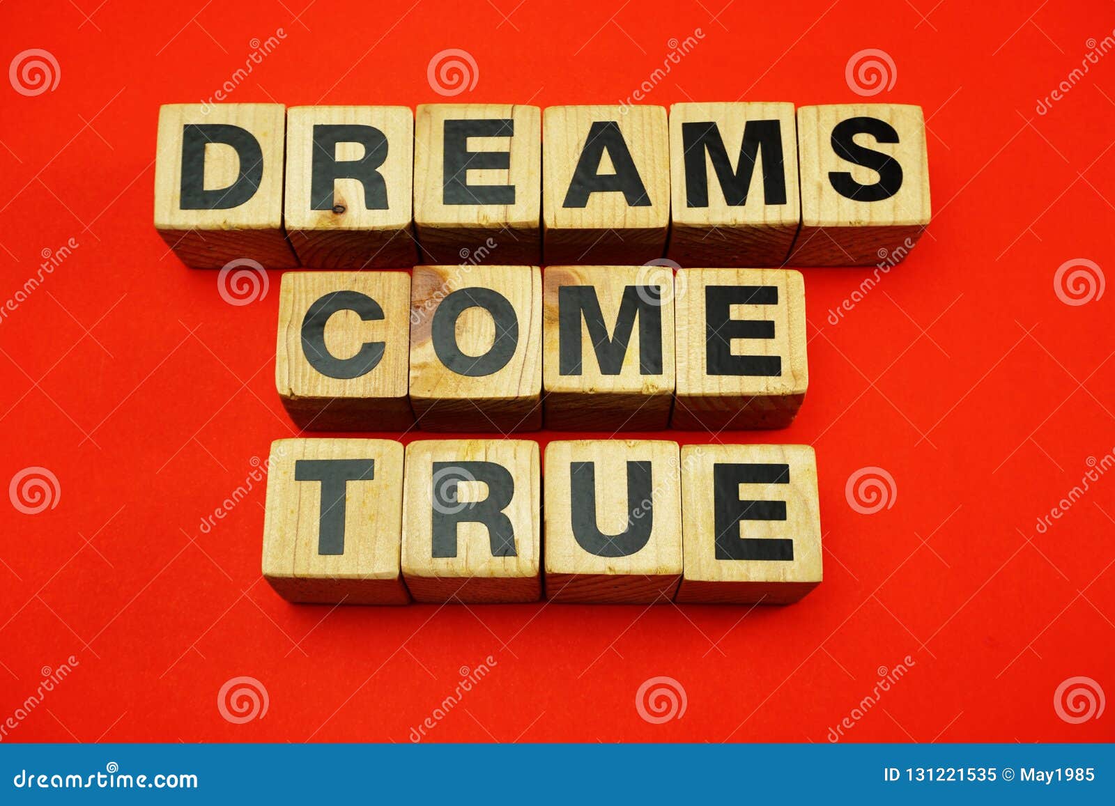 Dream Come True Word Created with Cubes Alphabet Letters on Red