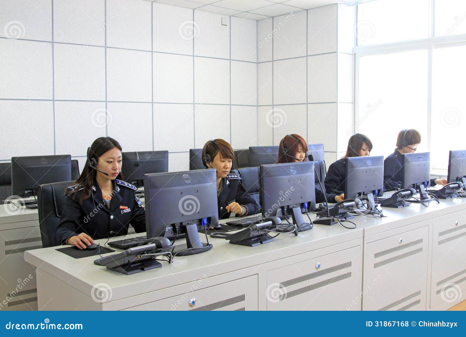 LUANNAN - APRIL 2: Dressed in women s uniforms administrators were busy working in a city traffic department on April 2, 2013, Luannan County, Hebei Province, china.