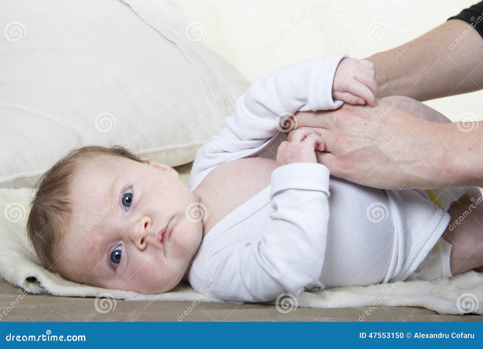 Dressing a baby stock photo. Image of bedroom, clothing 47553150