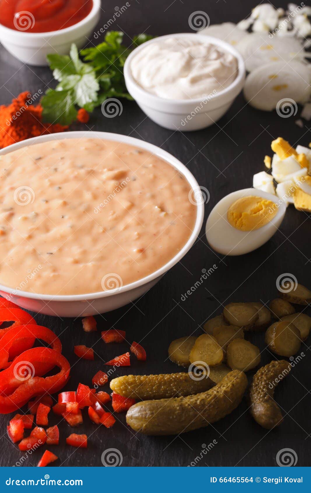 Dressing Thousand Islands Surrounded by Ingredients Closeup. Vertical