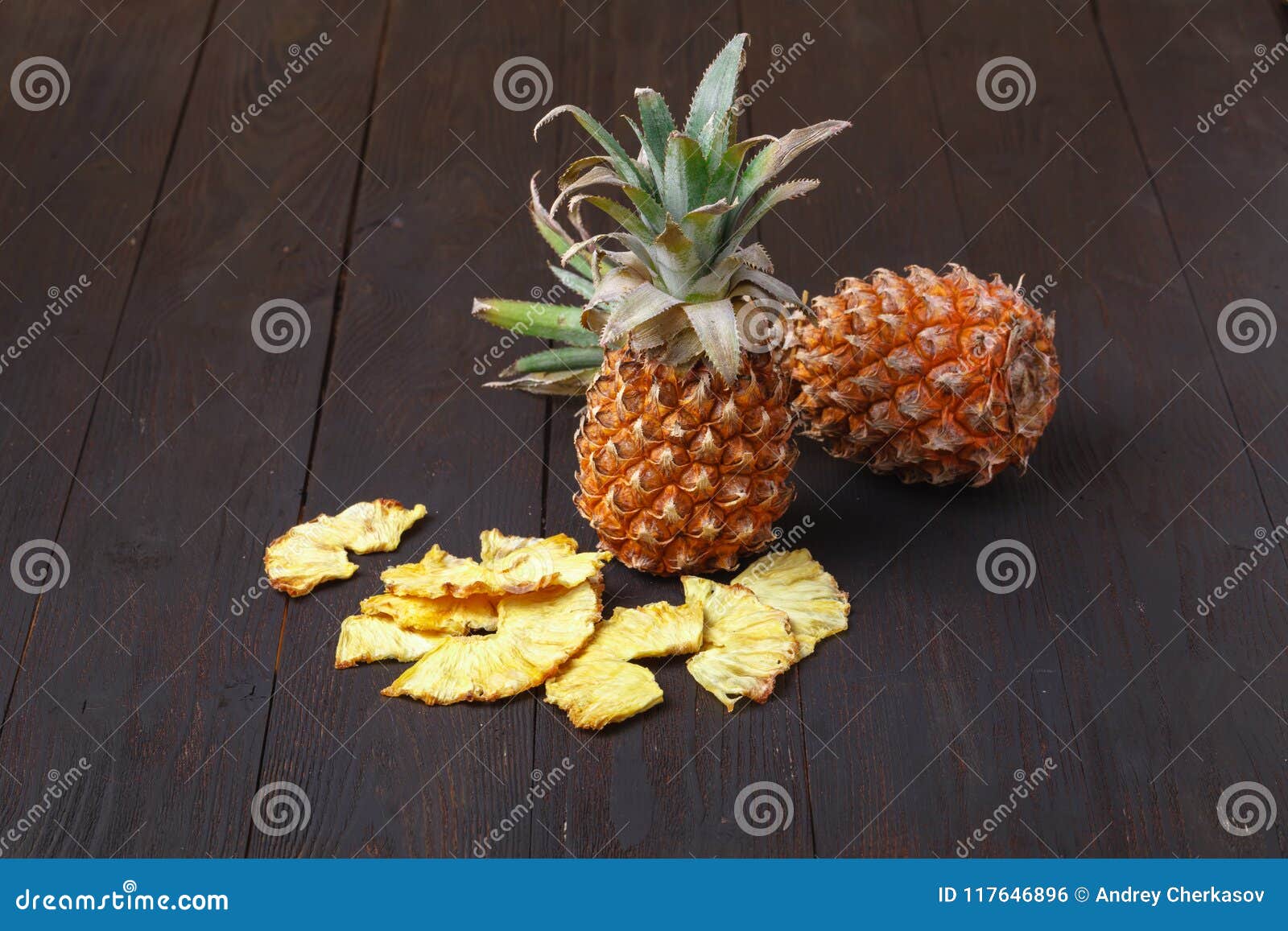 Dried Dehydrated Deep Fried Pineapple Chips in a Wooden Table Stock