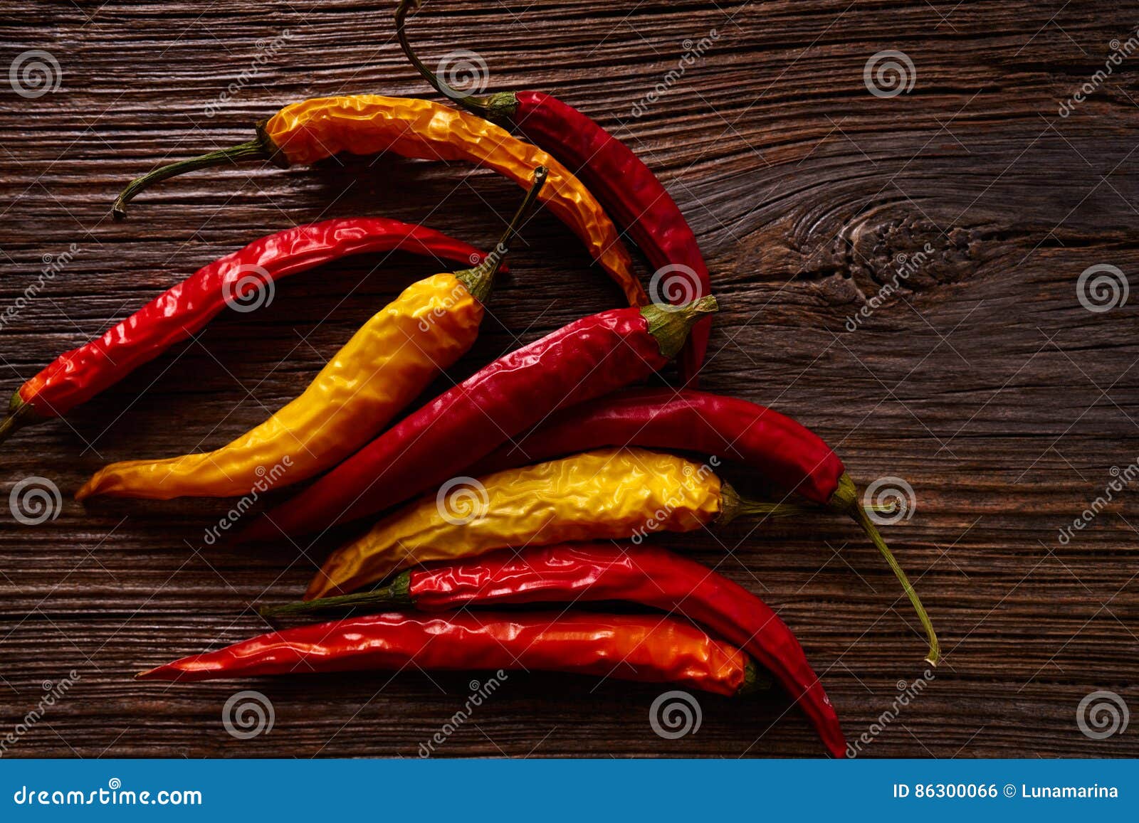 dried hot chili peppers on aged wood