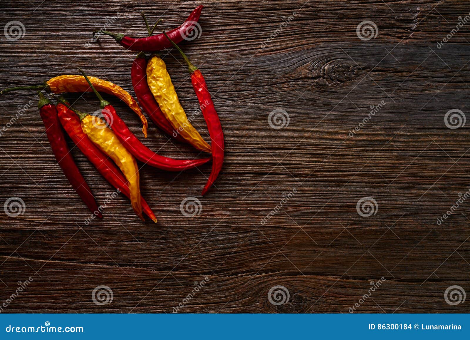 dried hot chili peppers on aged wood