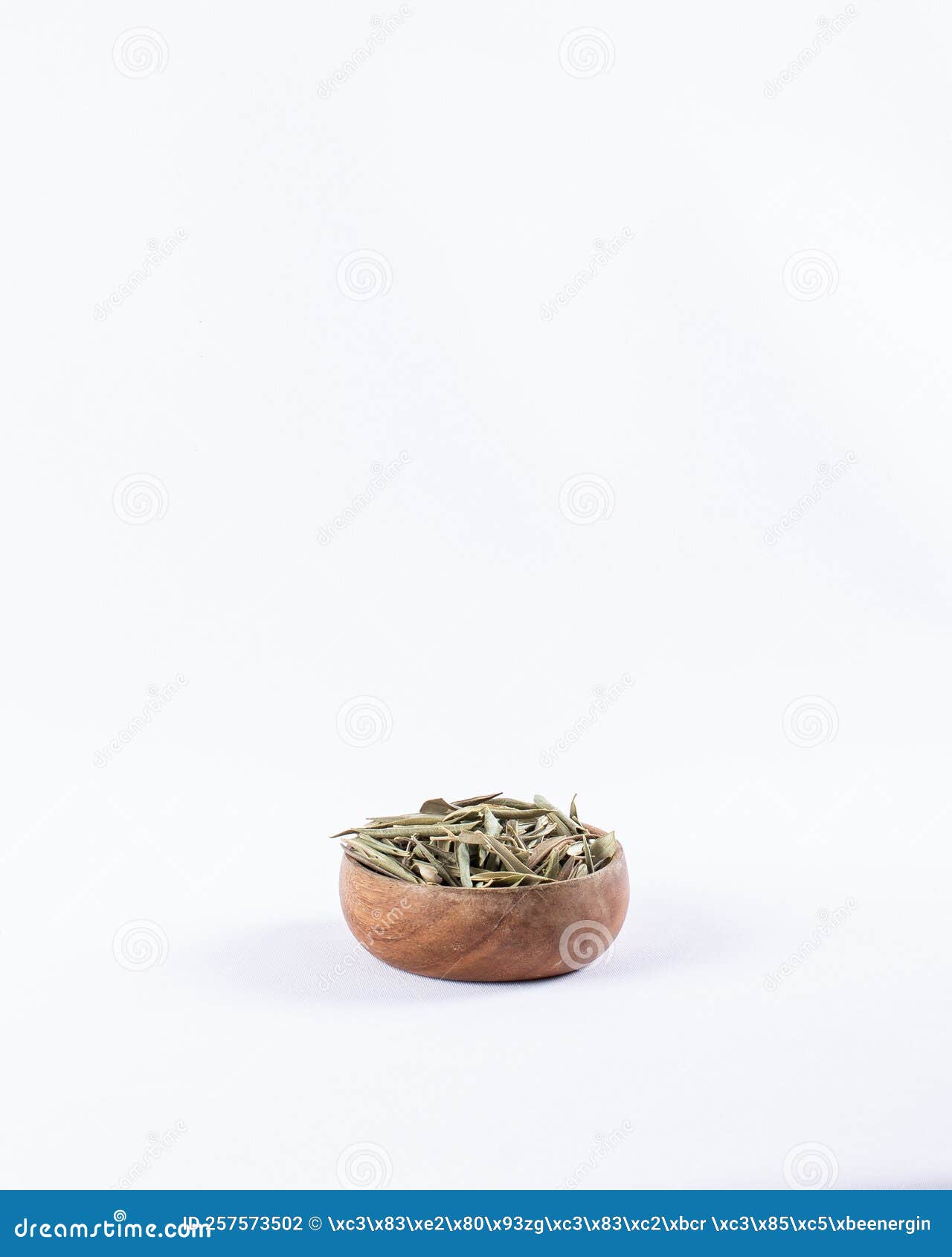 Dried Organic Olive Leaves in a Bowl on a White Background. Dried Olive