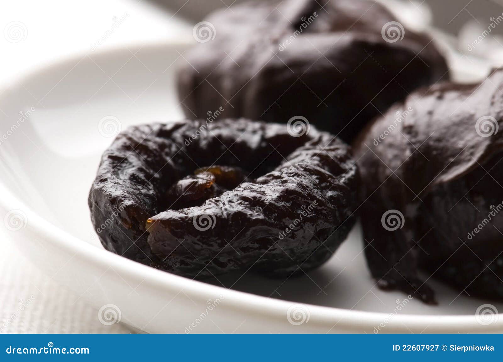 Dried plums in chocolate stock image. Image of black 22607927