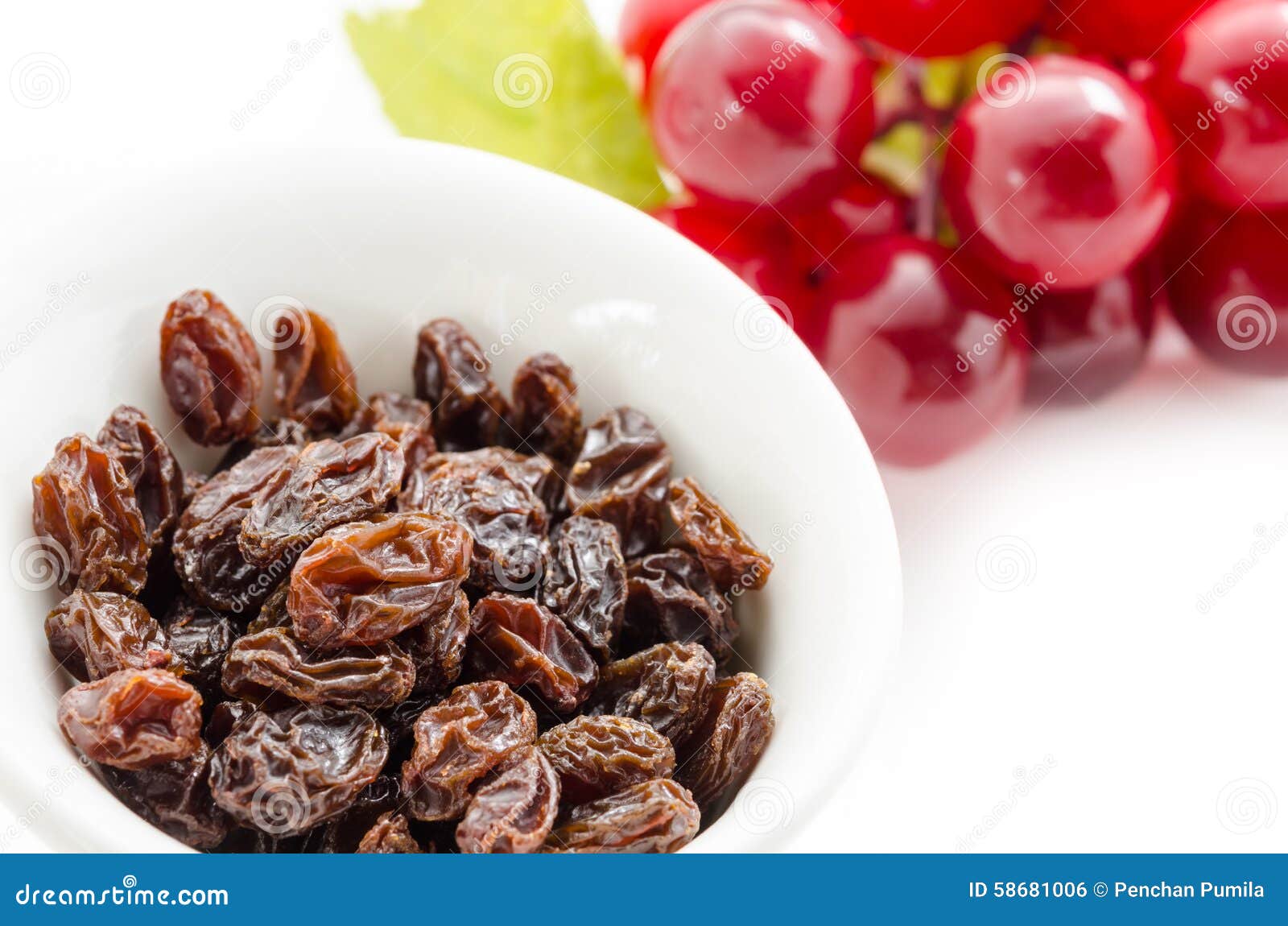 Dried Raisins in White Cup and Fresh Red Grapes. Stock Photo Image of
