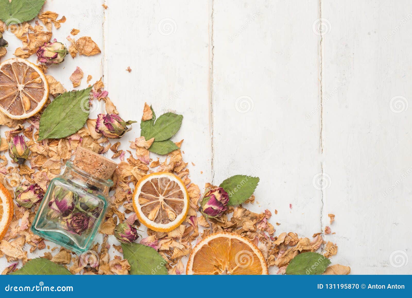 dried roses and roses in a glass jar with dried oranges. the concept of spa and body care. top view, with empty space for inscript