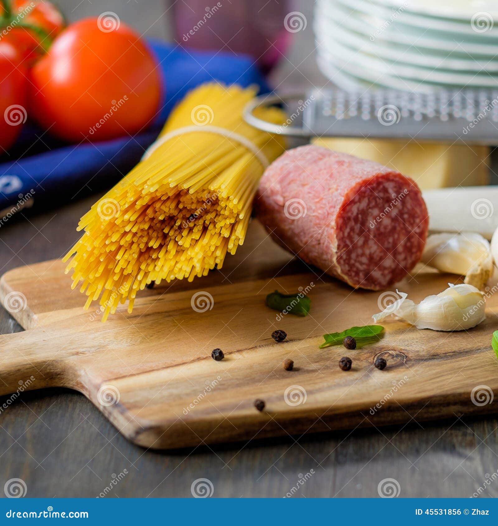 Dried Spaghetti Pasta with Some Salami on the Side and Tomatoes Stock