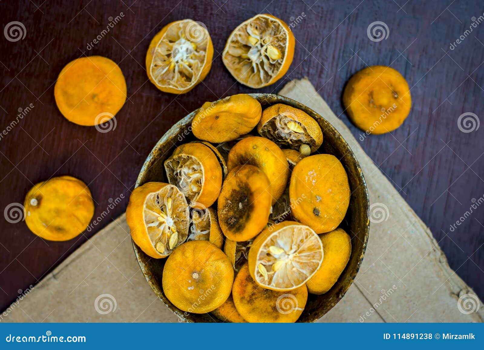 dried squeezed lemons,citrus Ãâ limon in a rusted bowl on wooden surface.