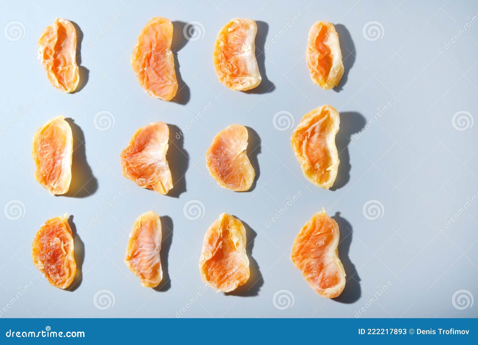 Dried Tangerines on Light Blue Background, Pattern of Candied Fruit