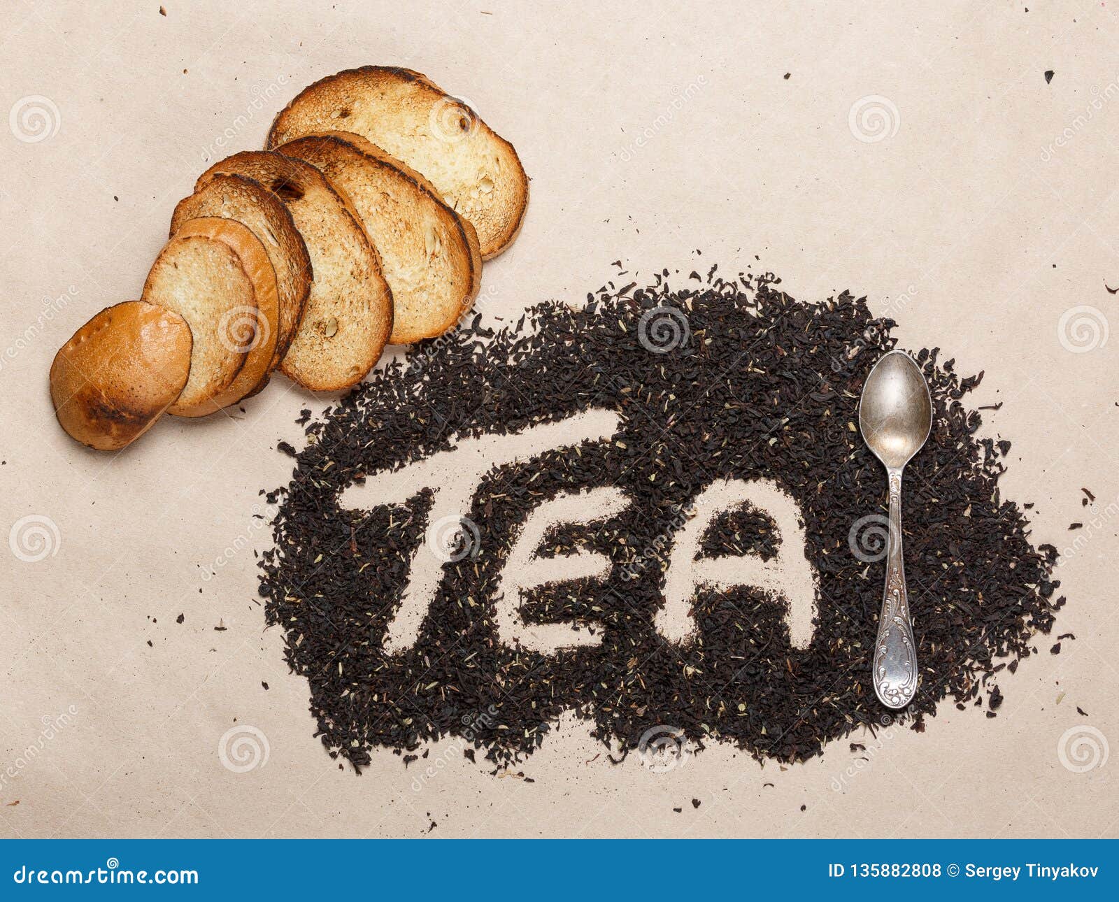 Dried Tea Leaves, a Teaspoon and Toast Top View. Creative Concept Stock