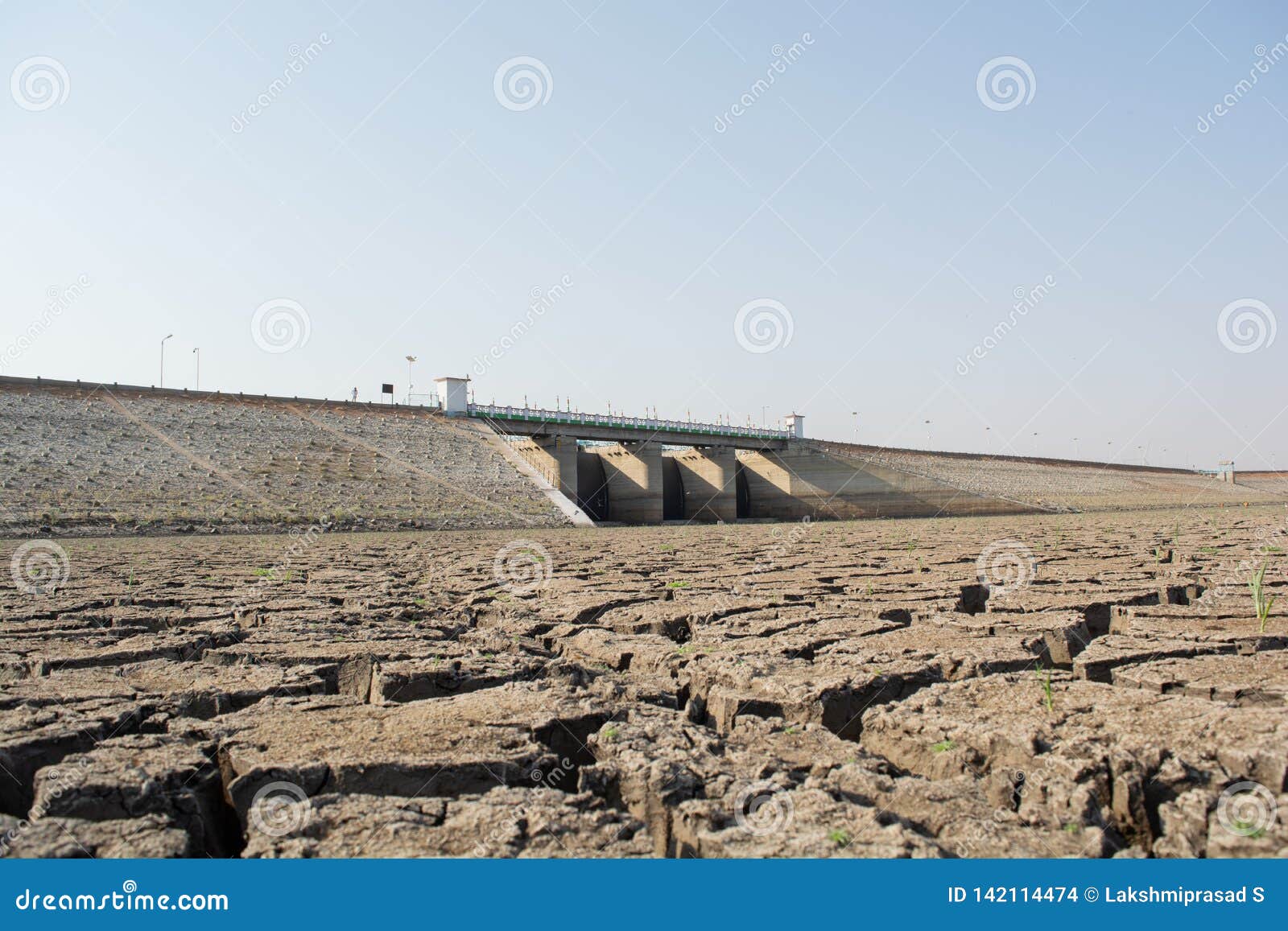 a dried up empty reservoir or dam during a summer heatwave, low rainfall and drought in north karnataka,india