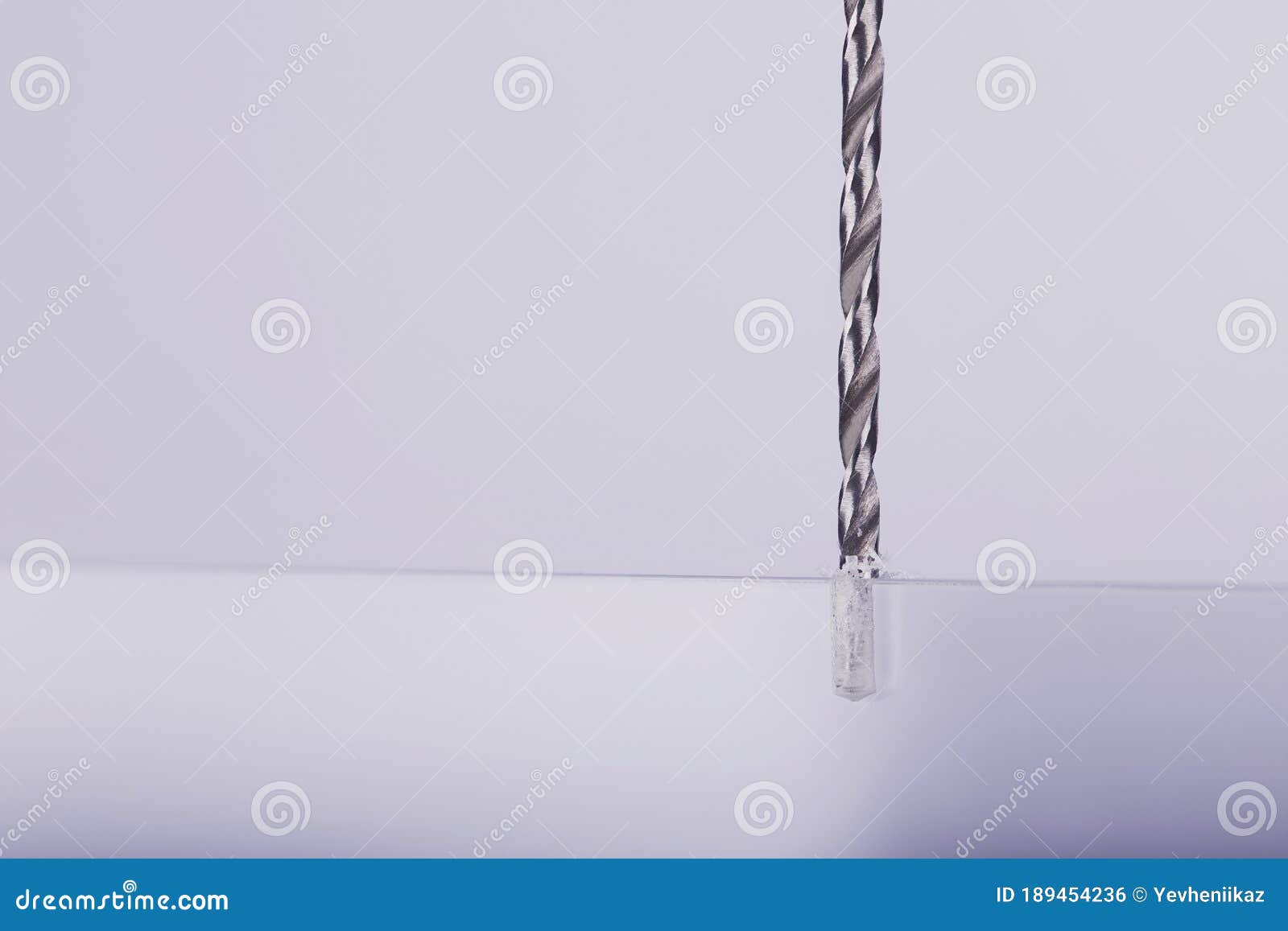 Drill Bit Make Holes in Opacity Plastic, Glass Billet Stock Photo
