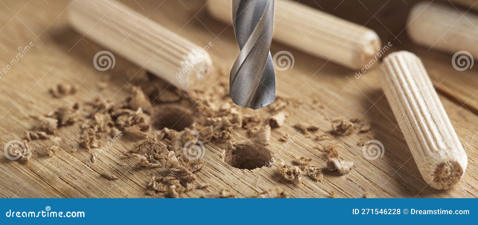 Drill Bit Makes Hole in Wooden Oak Board for Wooden Dowel Stock Photo