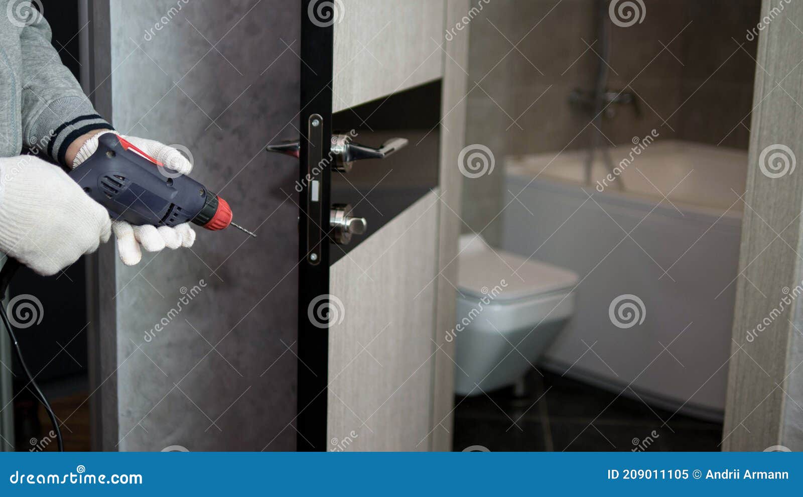 Drill Door Lock Door Repairman Man Repairs Interior Doors. Stock Image