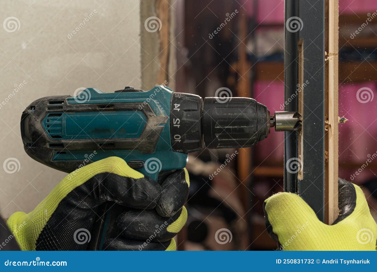Drilling a Hole in the Door with a Green Screwdriver, Closeup of the