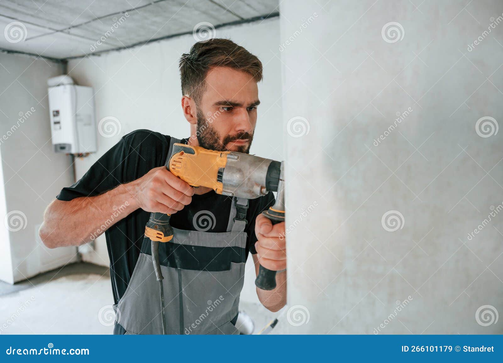Drilling the Hole in Wall. the Man is Making Repairs in the Apartment