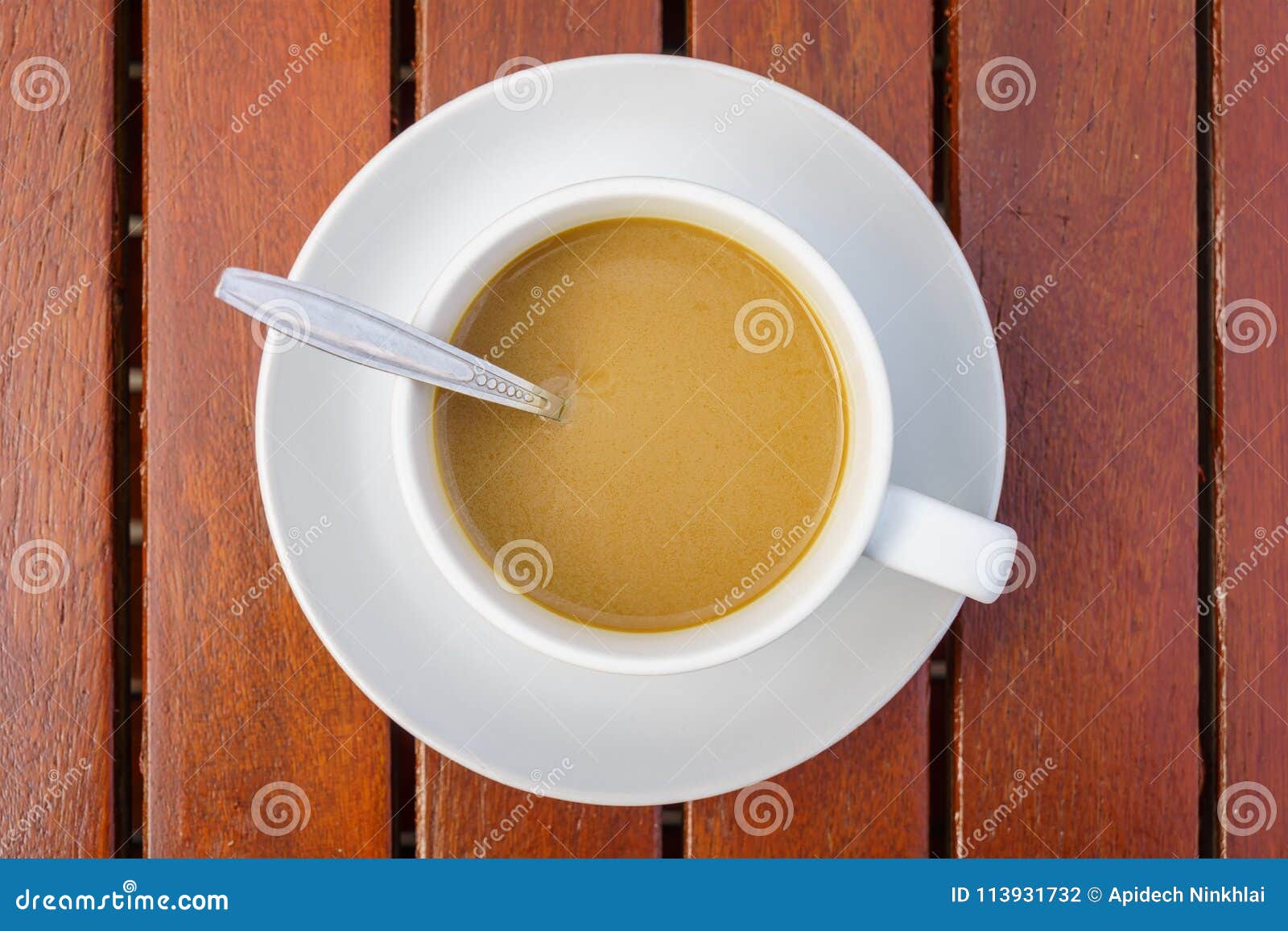 Top View of White Ceramic Cup with Saucer and Silver Teaspoon of Coffee