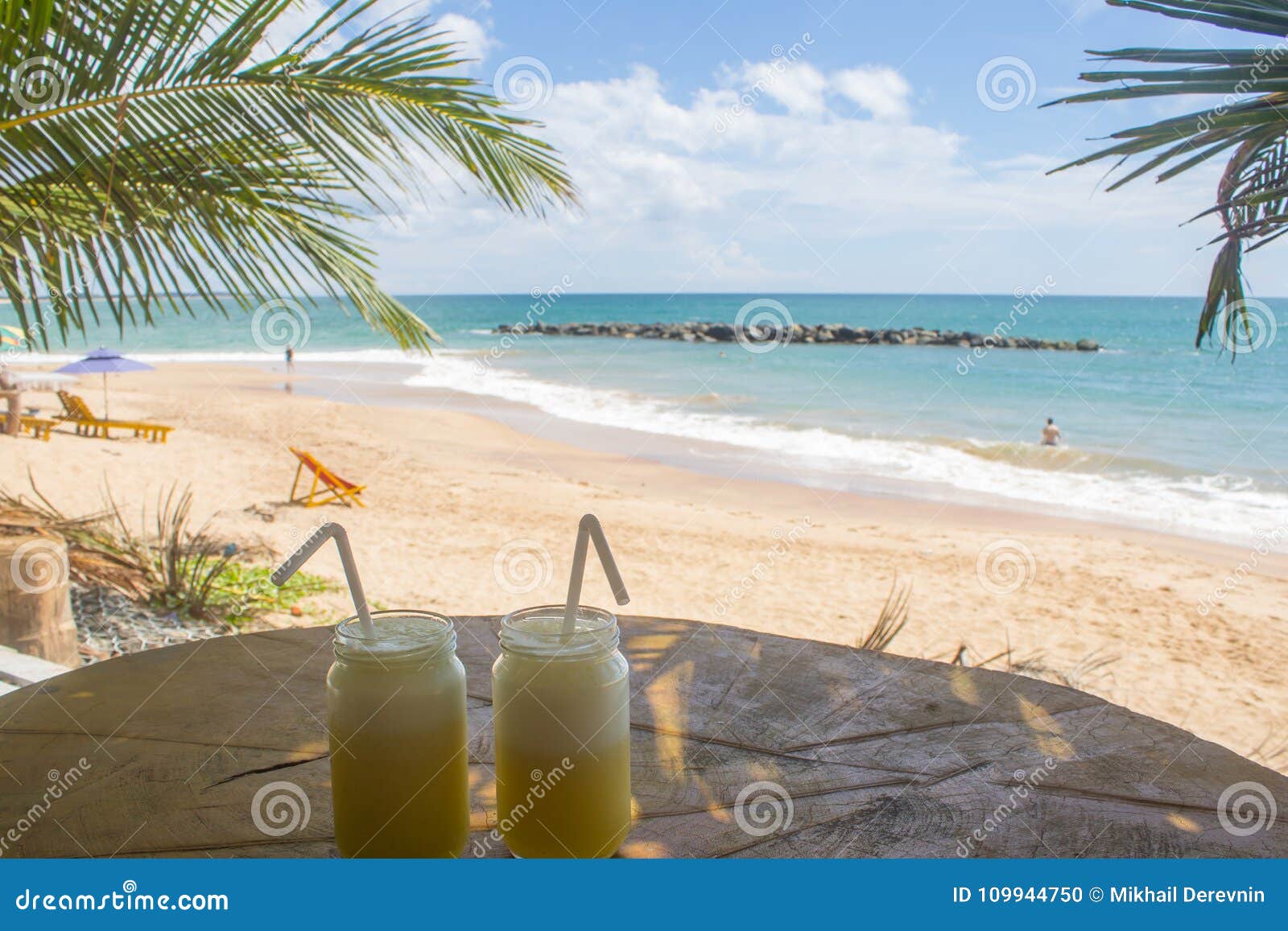 drink. view of nice tropical beach with palms around.