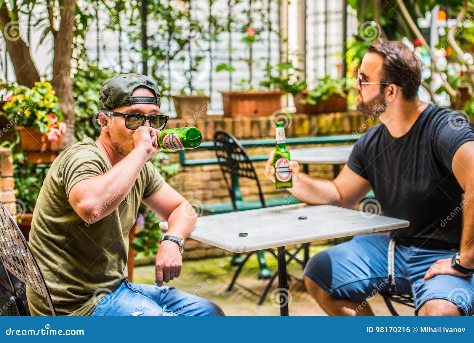 Drinking beers in a bar stock photo. Image of adult
