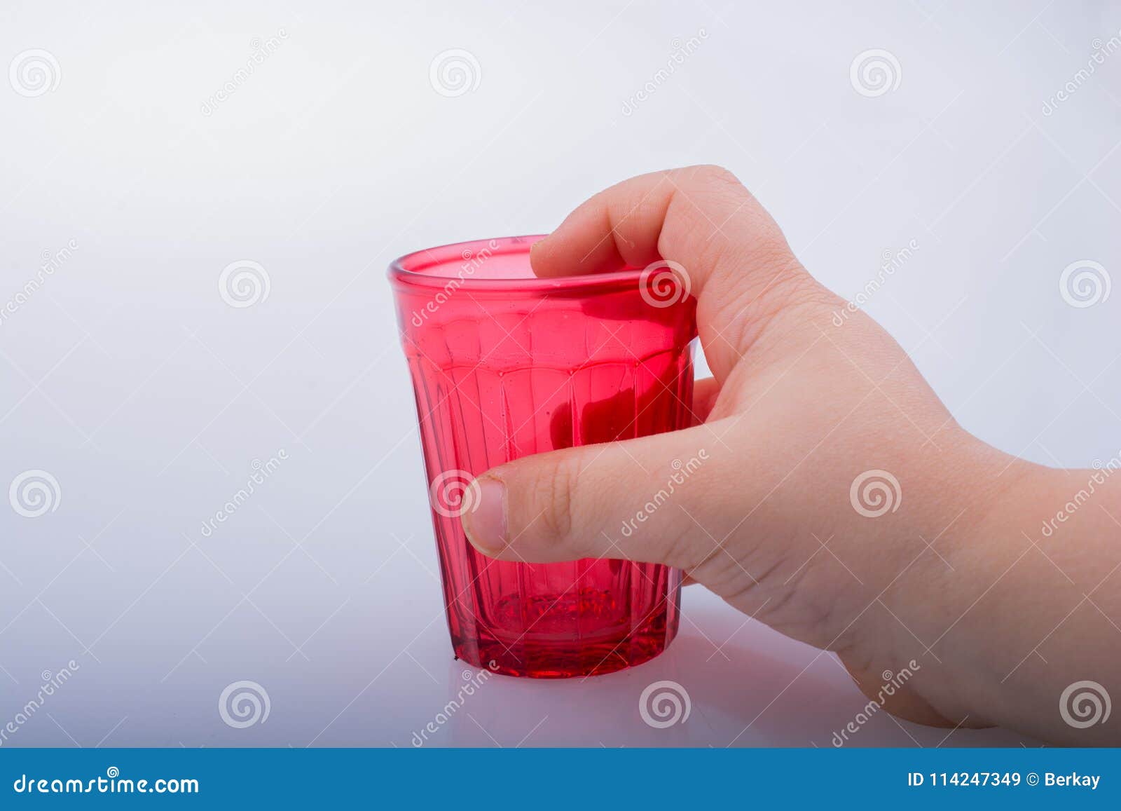 Drinking Glasses of Red Color in Hand Stock Image Image of drinks, fizzy 114247349