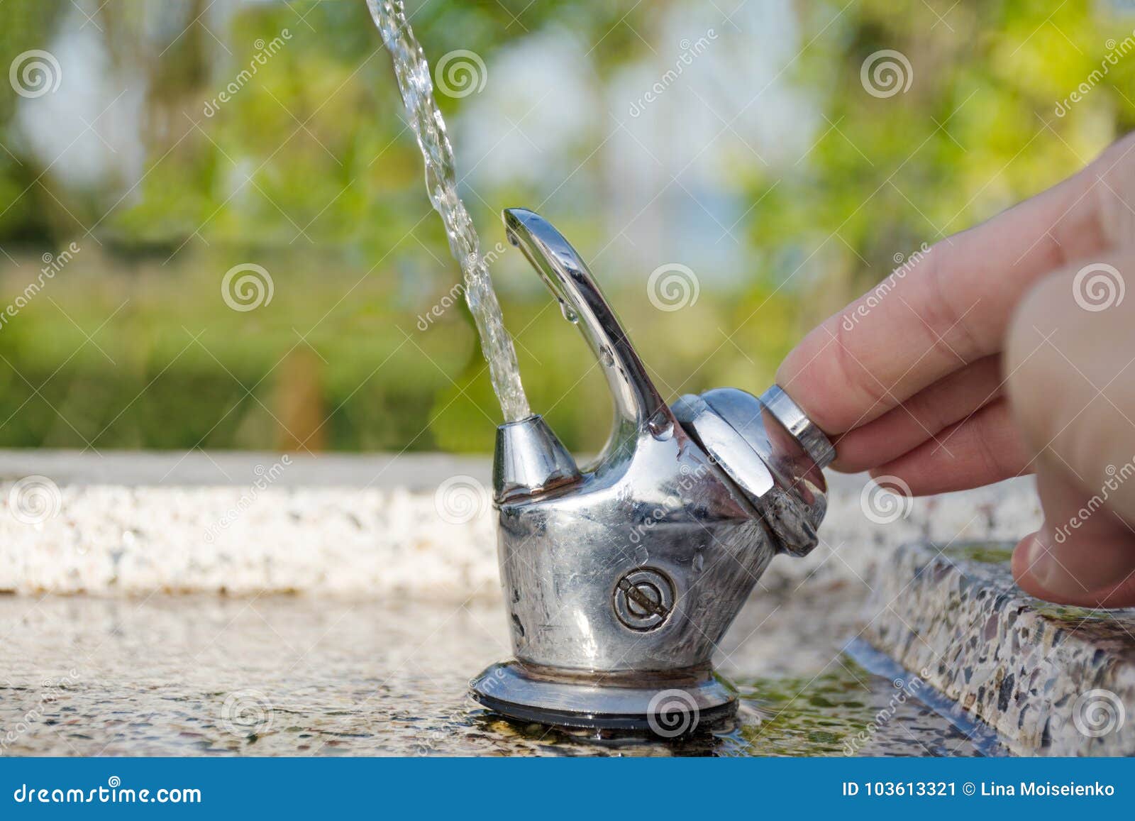 Drinking Street Fountain. He Hand Presses The Water Supply