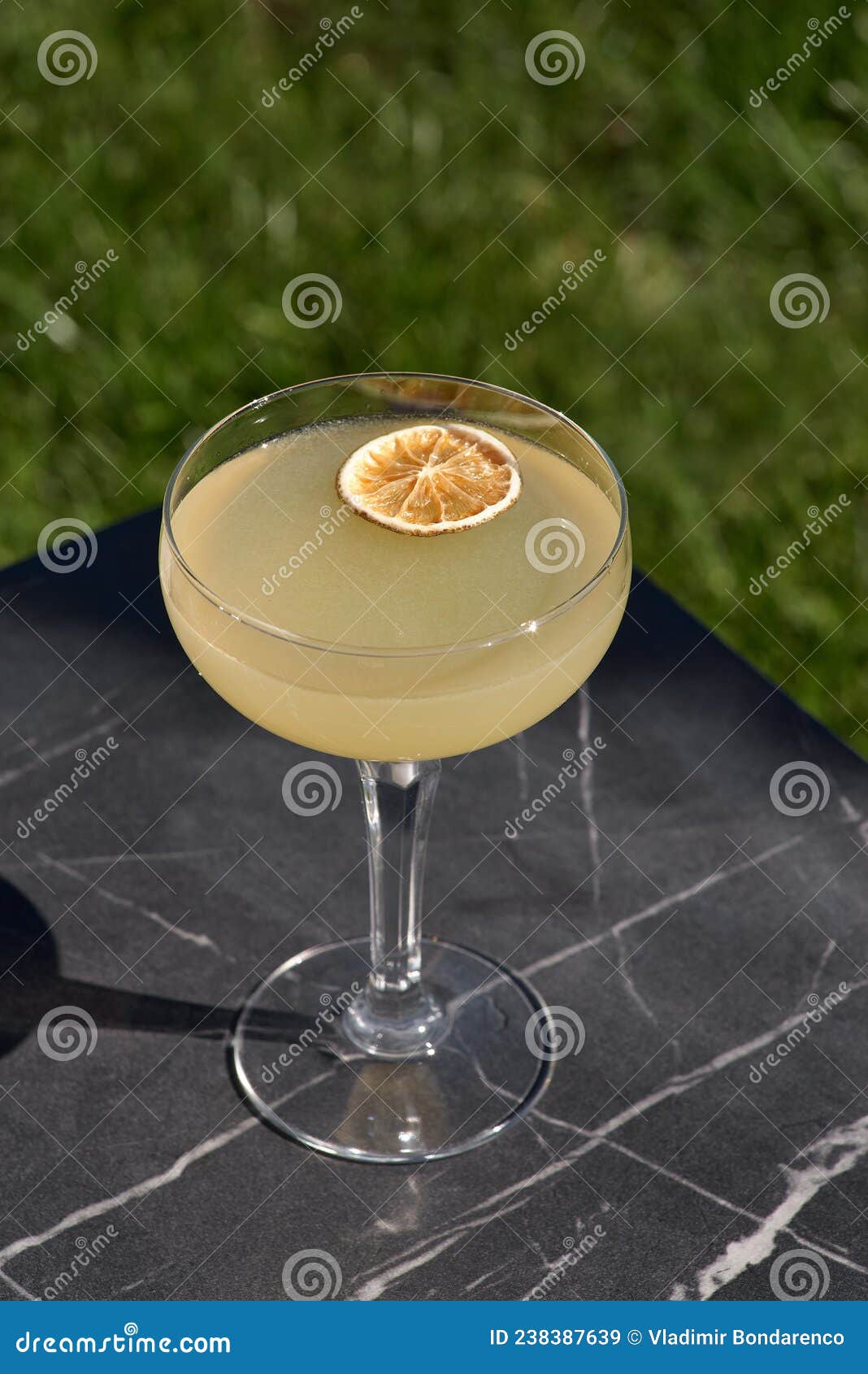 Drinks. Yellow Lemon Cocktail with Ice on a Dark Background Stock Image