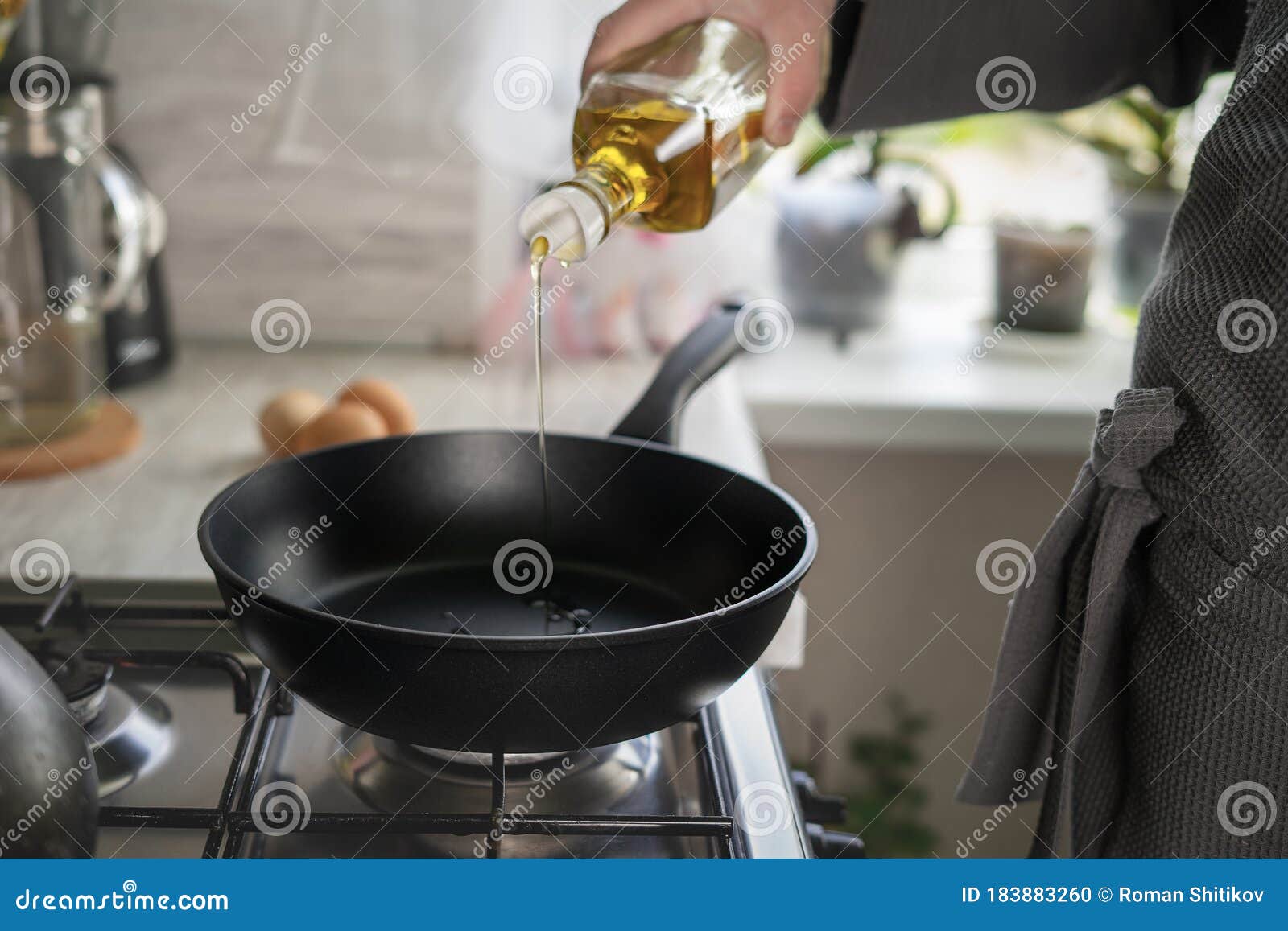 Dripping Pan, Olive Oil and Black Induction Cooker. Stock Photo Image