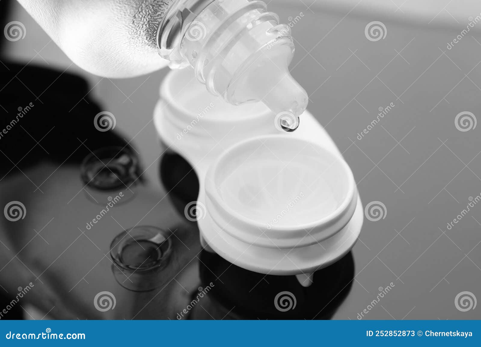 Dripping Solution into Case with Contact Lenses on Table, Closeup Stock