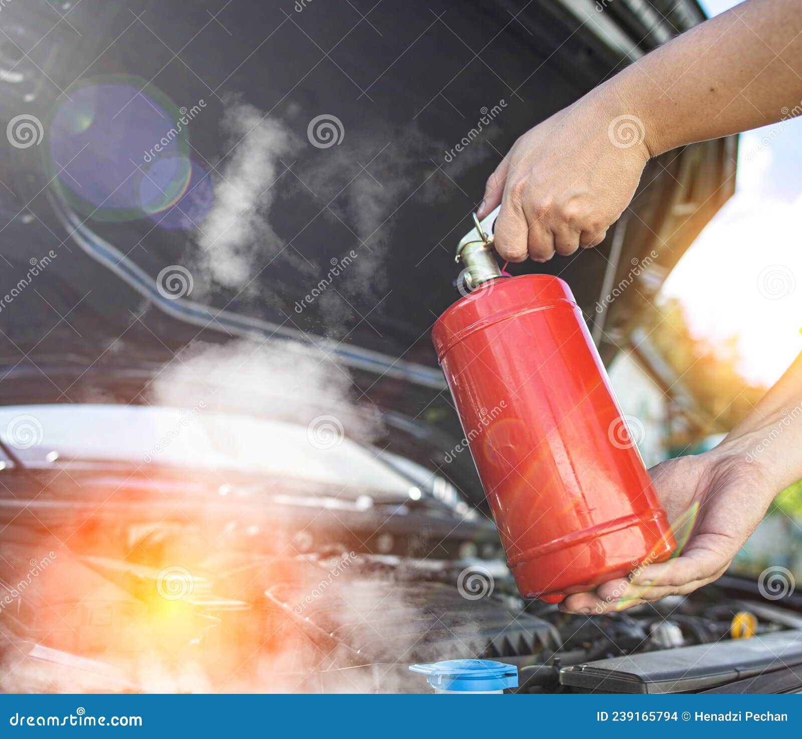 The Driver of the Car Directs a Powder Fire Extinguisher at the Engine