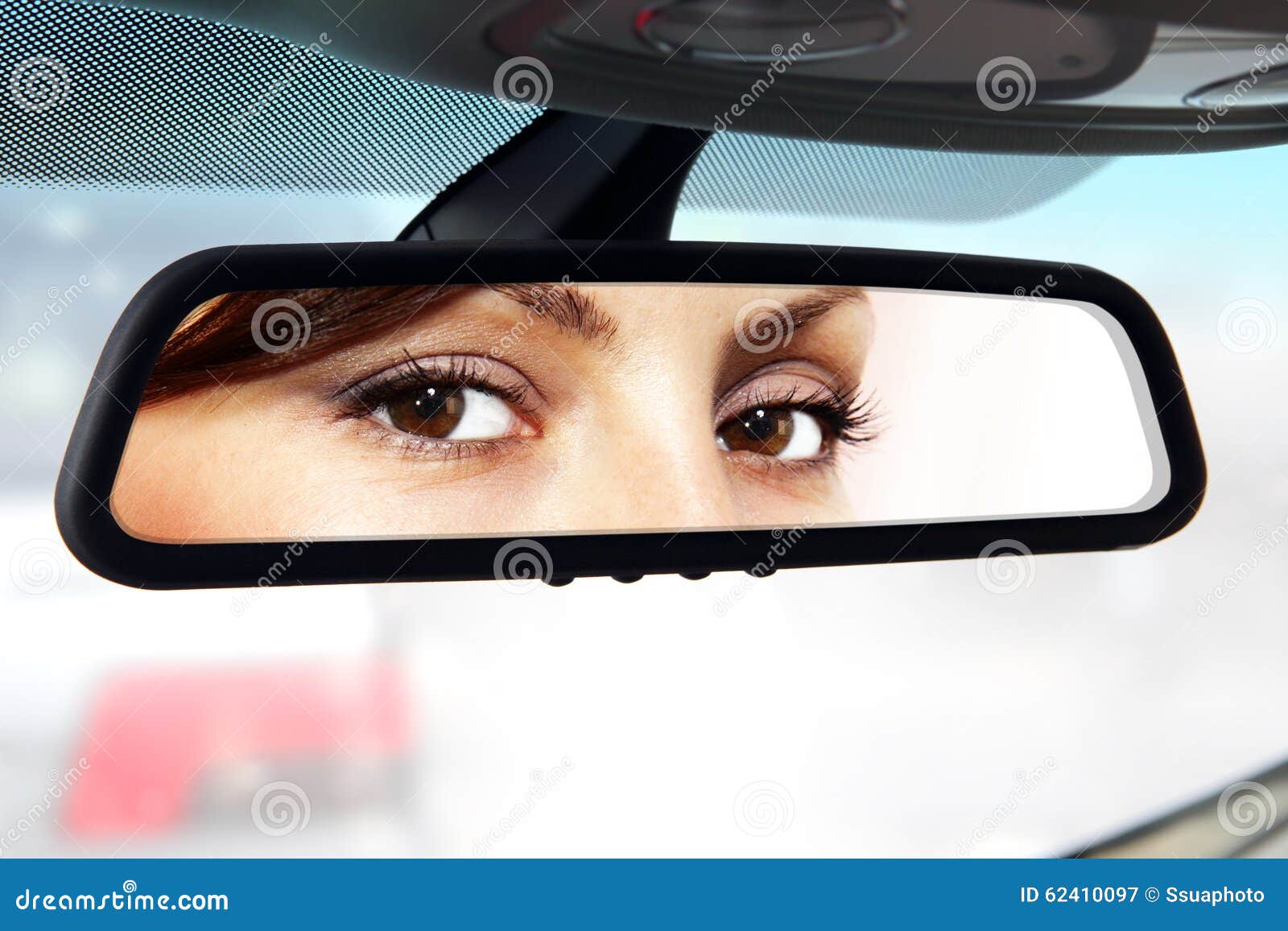 driver looks to rear-view mirror