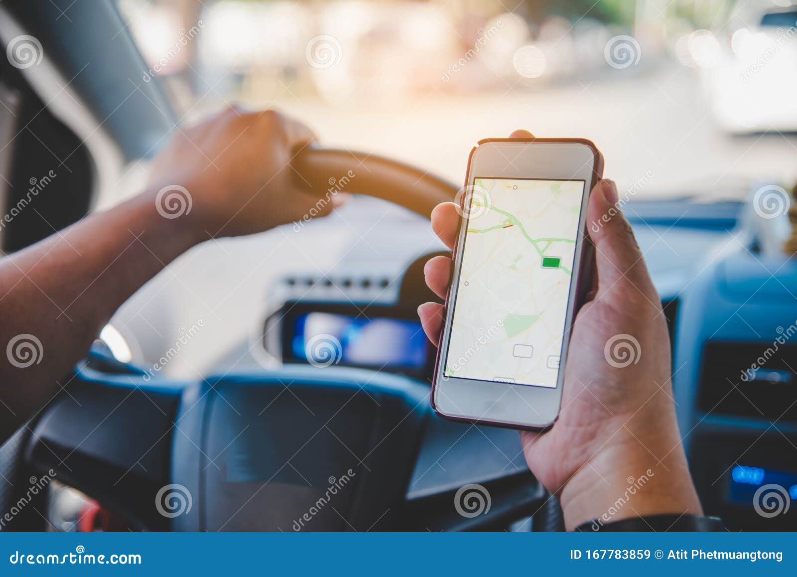 Driver Sitting in the Car and Holding Mobile Smart Phone with Map Gps