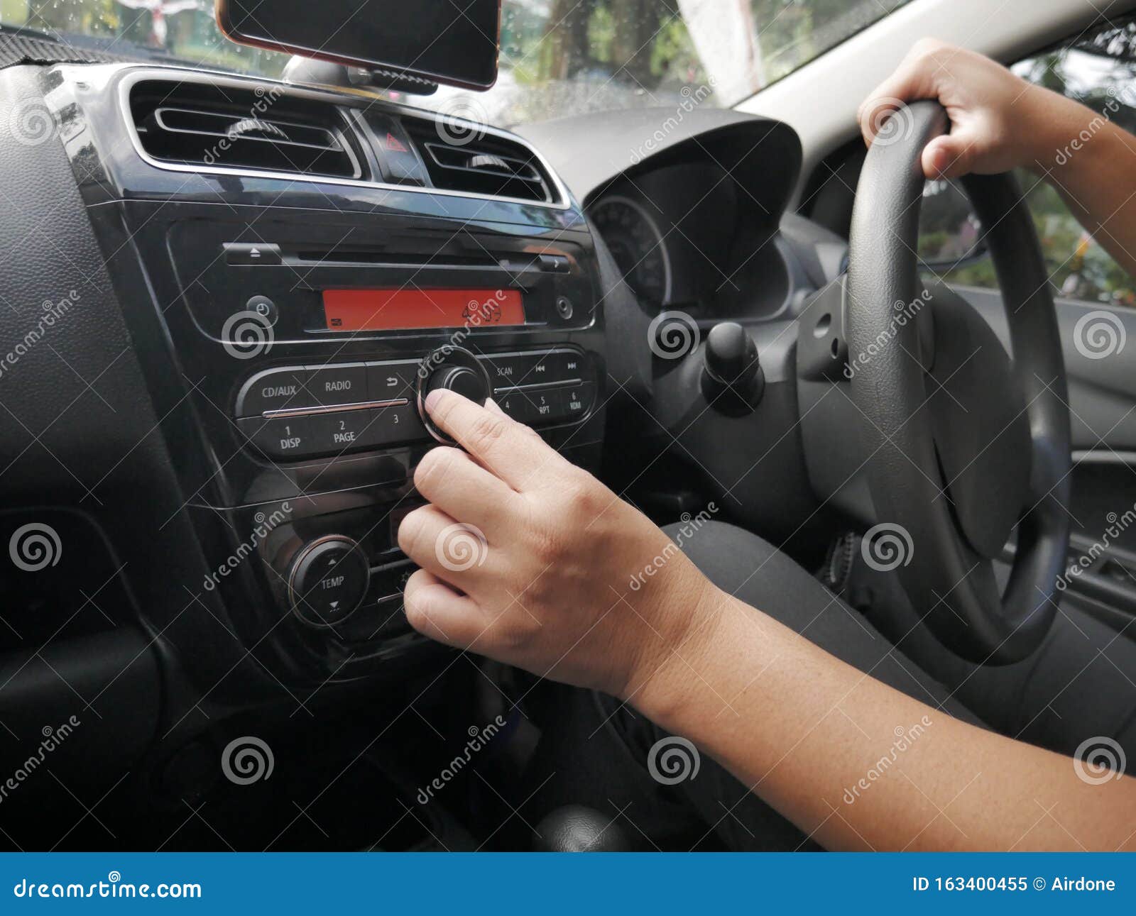 driver& x27;s hand press button on car radio
